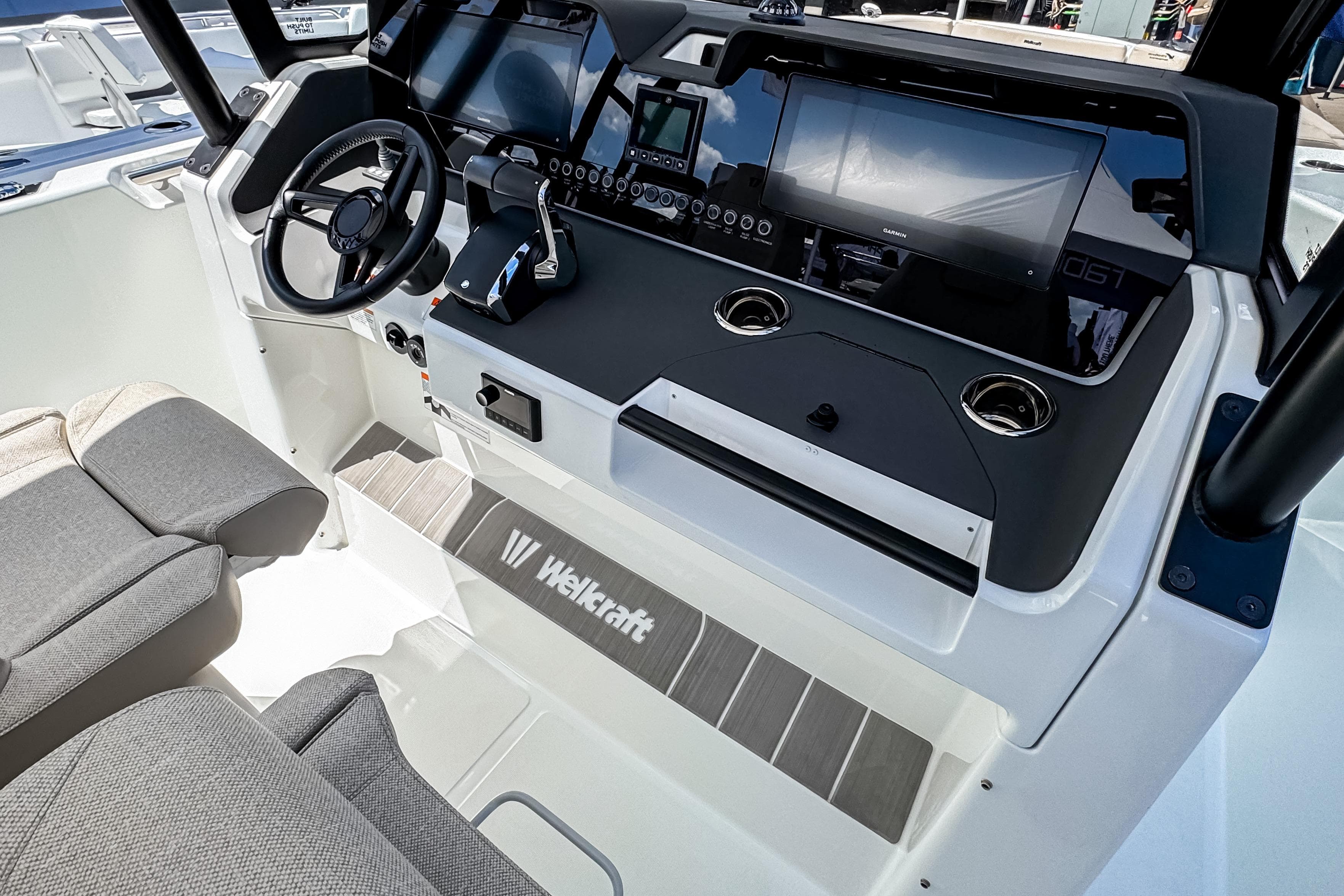 Interior view of 2026 Wellcraft 28 T-Top boat cockpit with modern controls.
