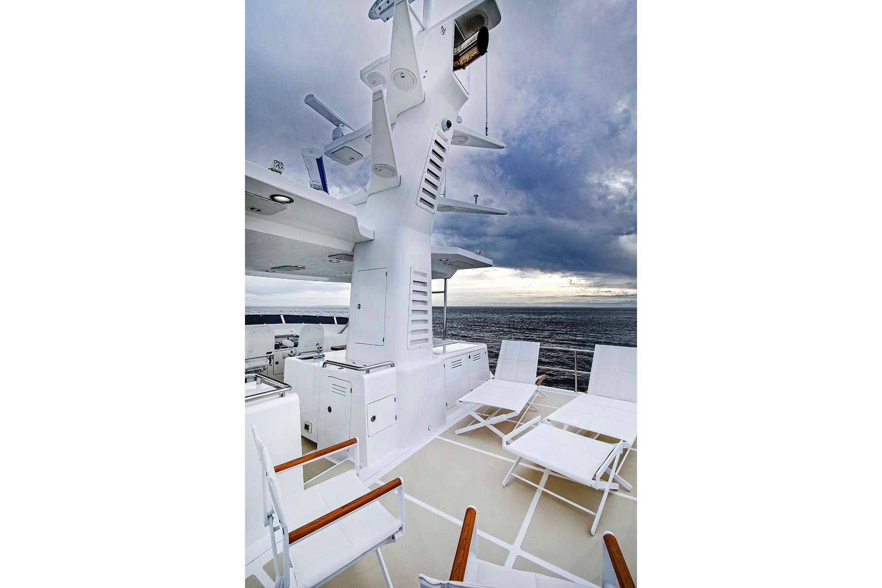 Nordhavn 76 yacht deck, 2018, featuring lounge chairs and ocean view.