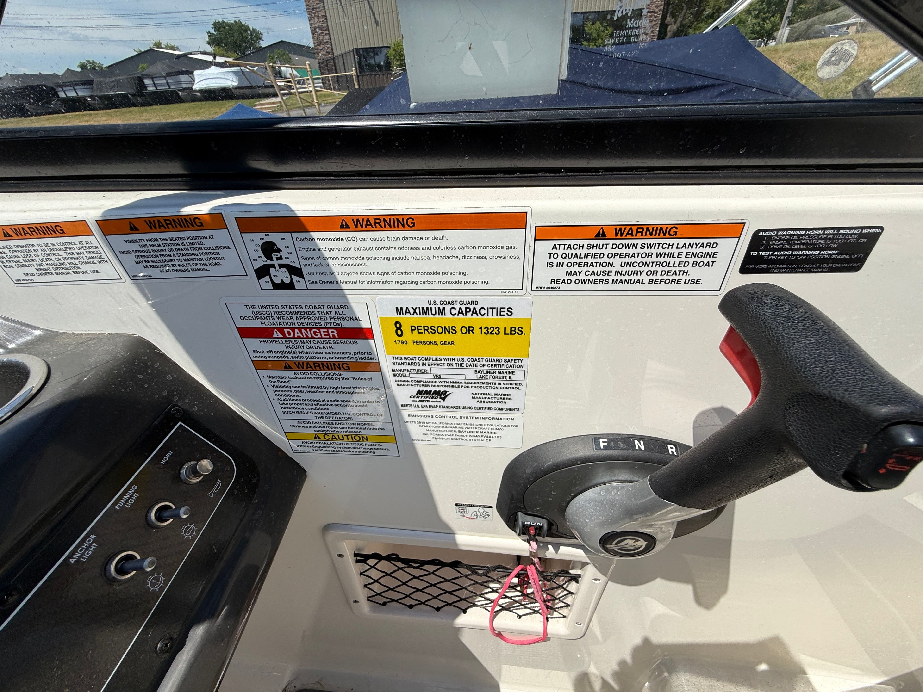 2019 Bayliner VR5 dashboard with warning labels and control lever.