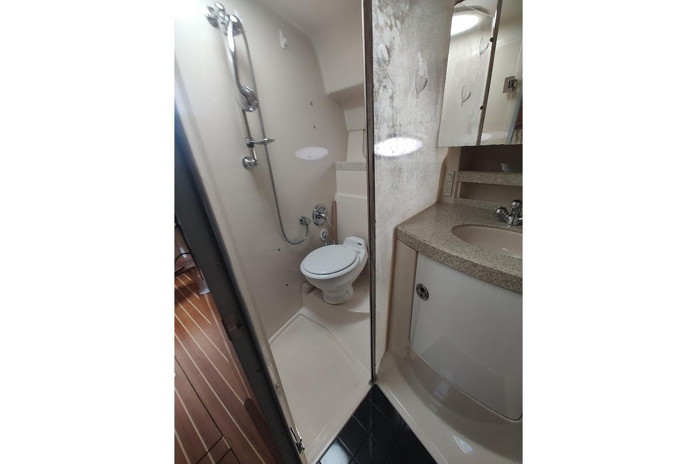 Bathroom interior of 2006 Regal Commodore 3560 IO yacht, featuring shower and sink.