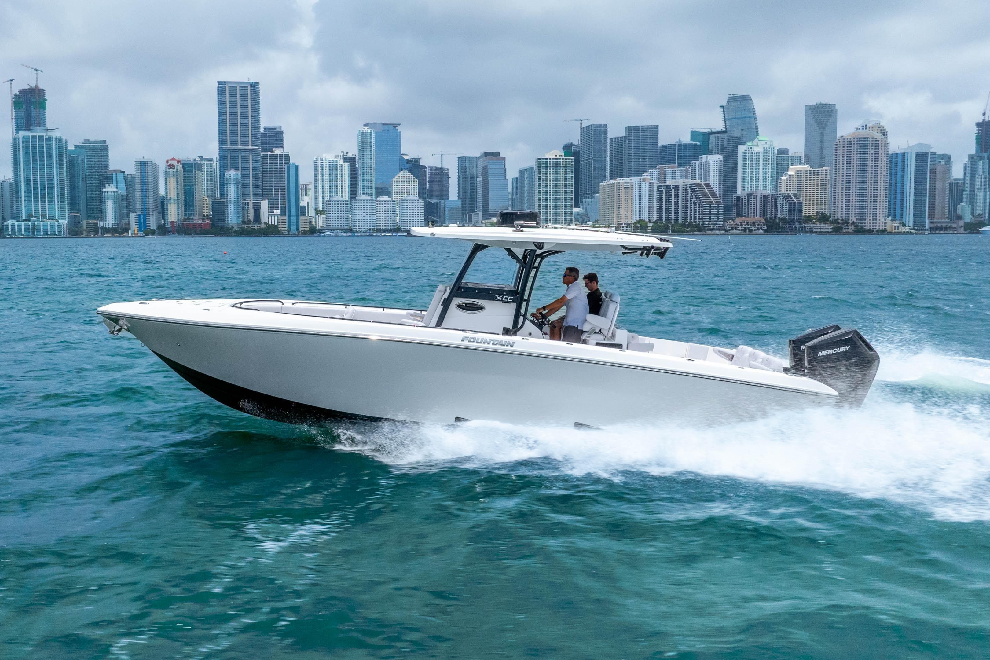 2025 Fountain 34 Center Console boat cruising near city skyline on a sunny day.