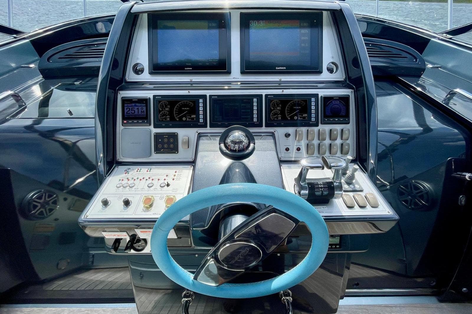 Cockpit of 2016 Riva 63 Virtus yacht with advanced navigation controls and displays.