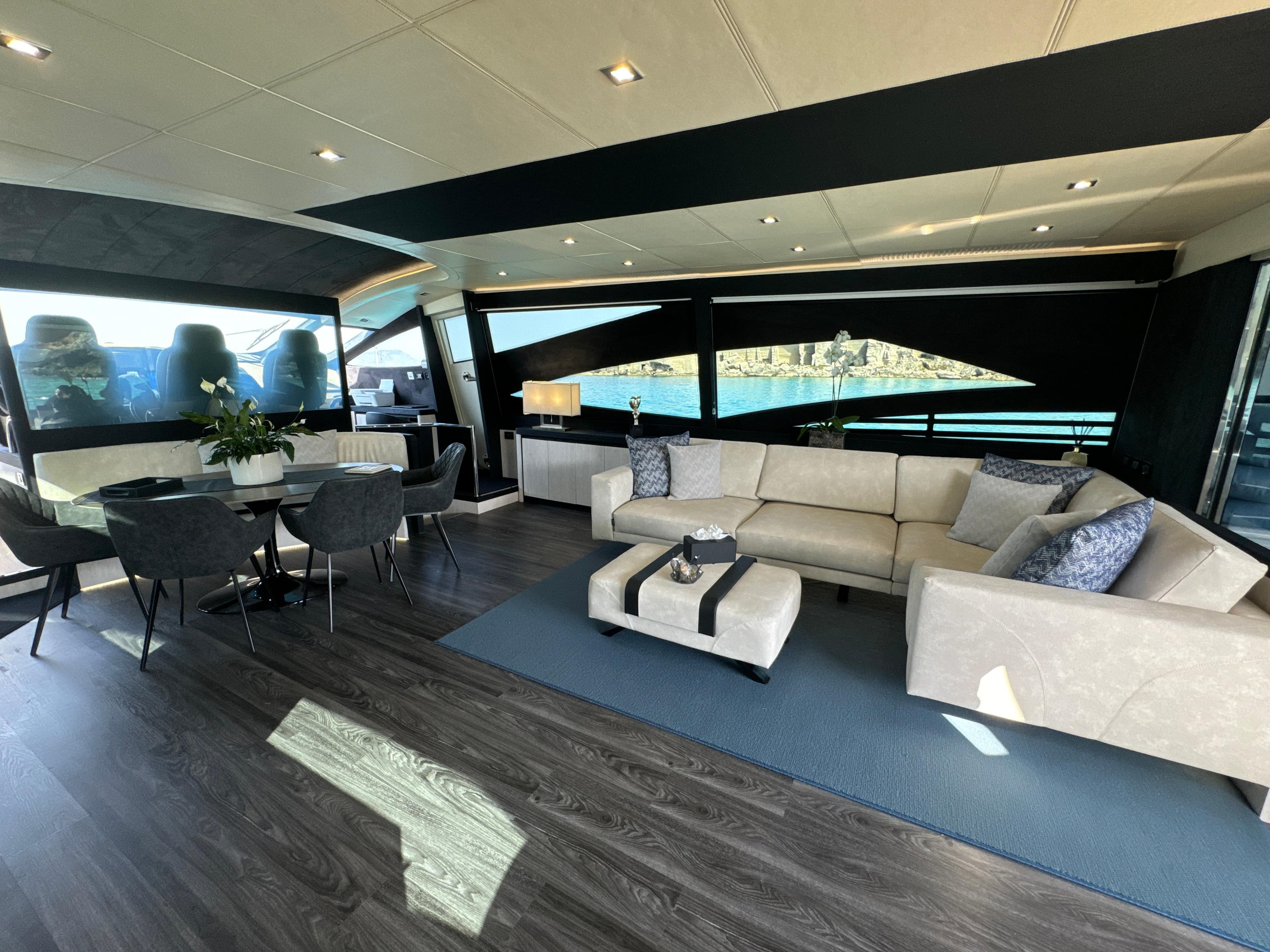 Luxurious interior of a 2008 Pershing 90 yacht with elegant seating and dining area.