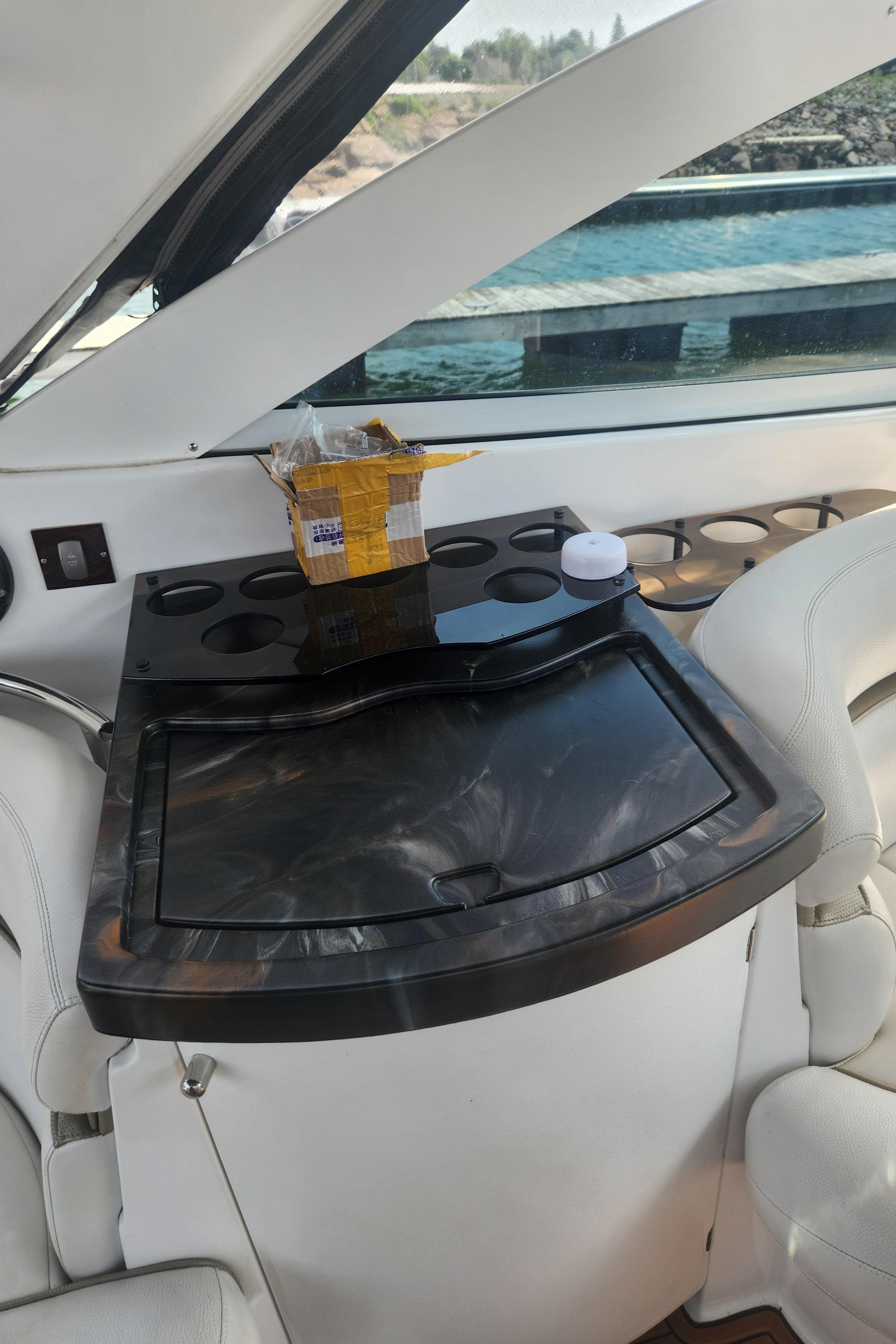 2006 Doral Boca Grande boat interior with sleek black countertop and cup holders.