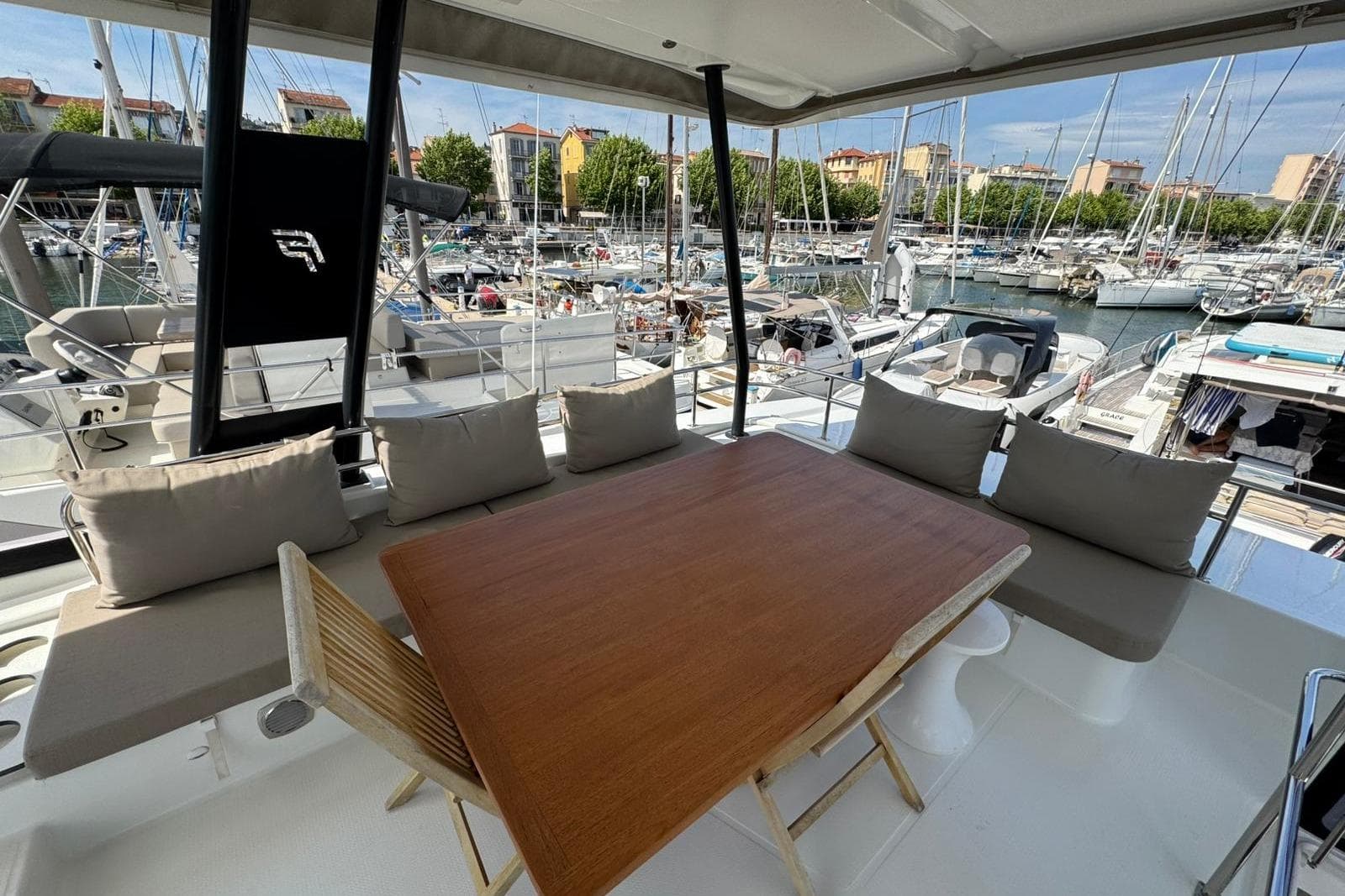 Fountaine Pajot MY 44 yacht, 2019 model, featuring a spacious outdoor seating area in a marina.