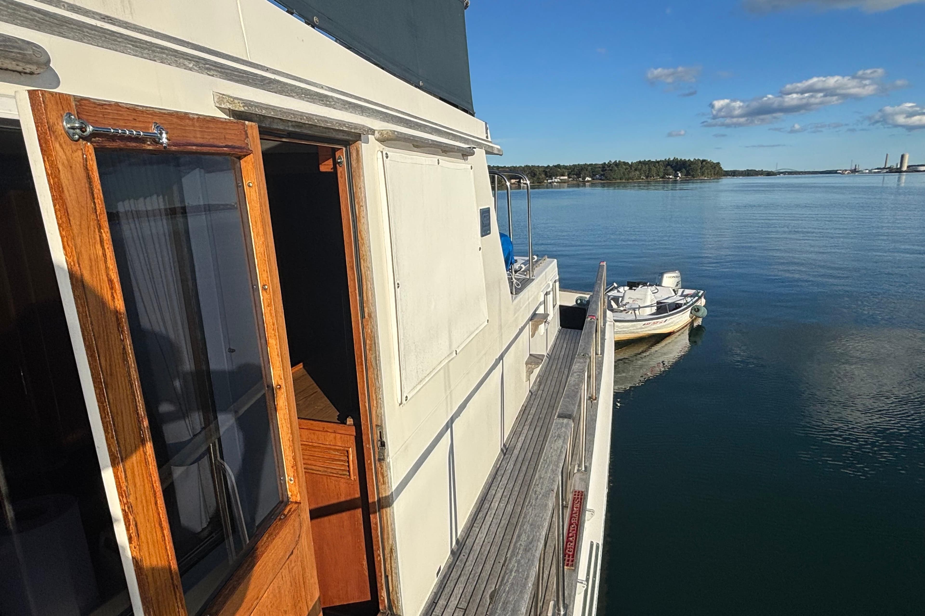 1989 Grand Banks 46 Classic yacht on calm water with clear sky.