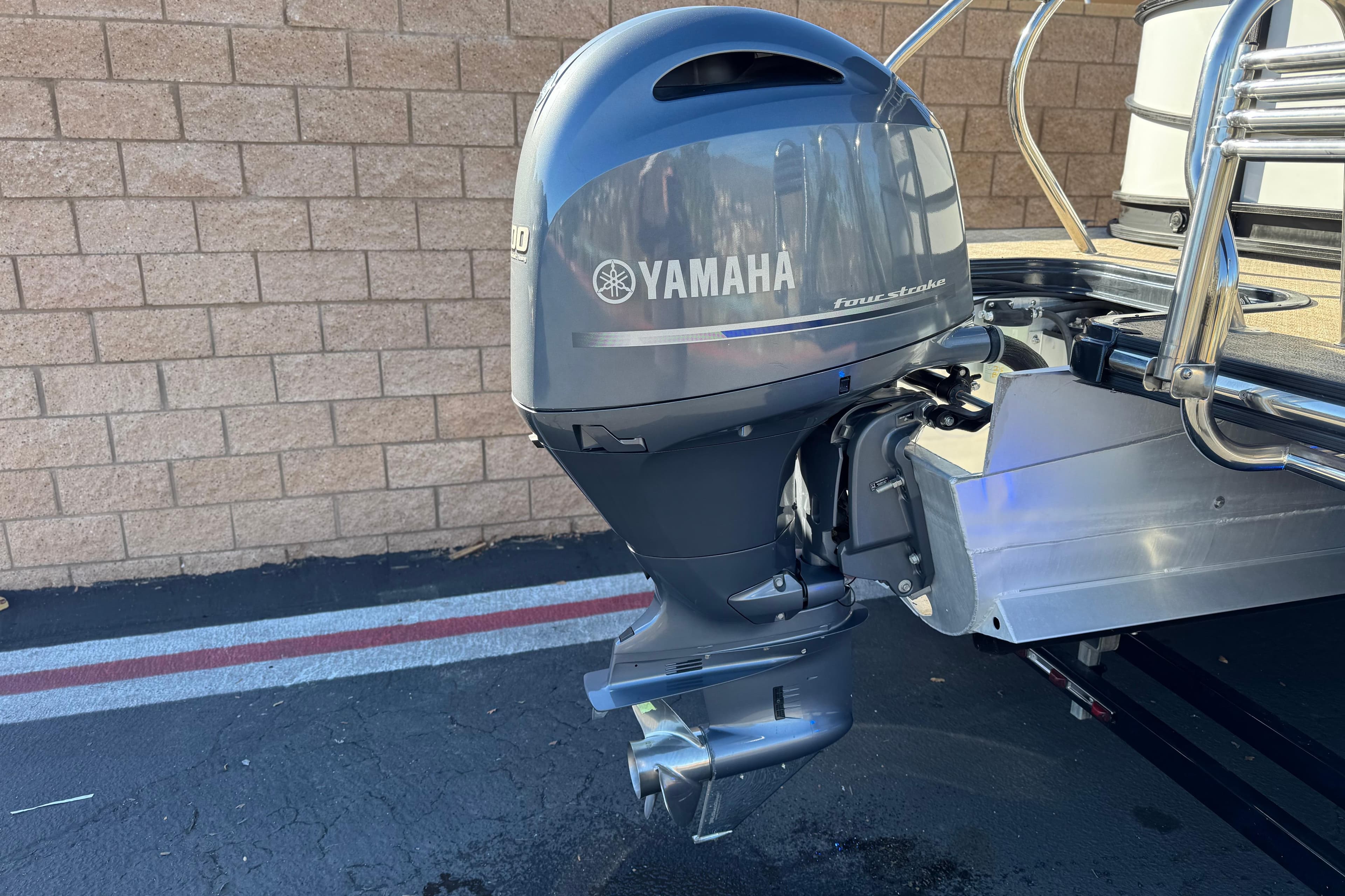 2021 Starcraft SLS 3 with Yamaha outboard motor, parked on asphalt near brick wall.