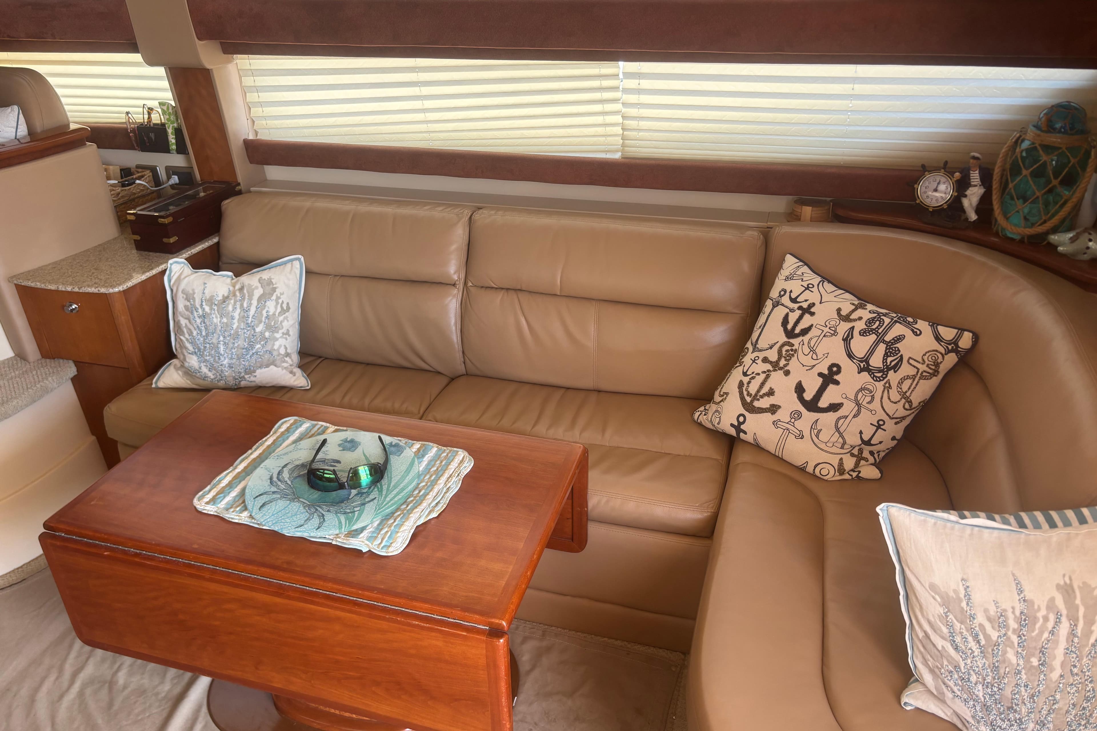 Luxurious interior of 2007 Meridian 391 Sedan with leather seating and nautical-themed decor.