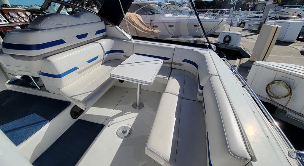 2003 Formula 31PC boat interior with white and blue seating, docked at marina.