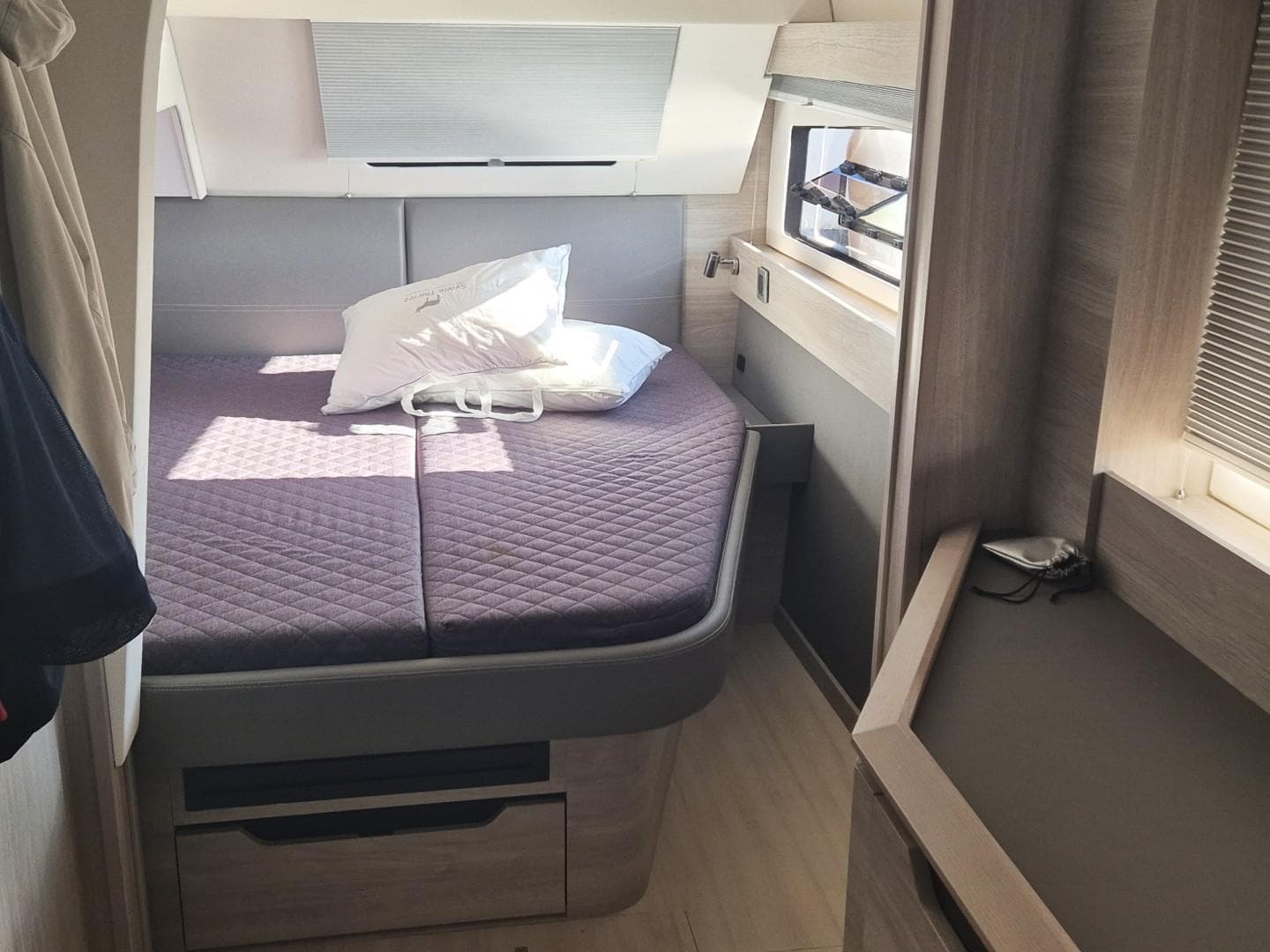 2023 Catana Ocean Class cabin with cozy bed and modern interior design.