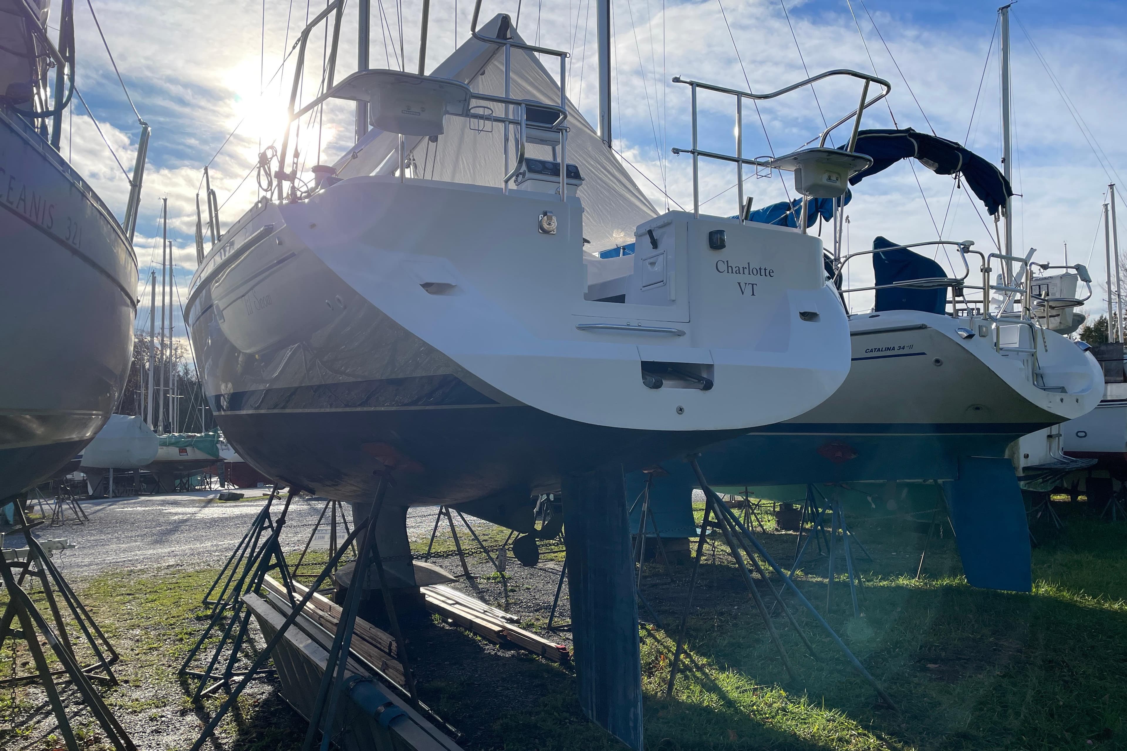 Catalina 355 sailboat from 2014 on stands, with sunlight in the background.