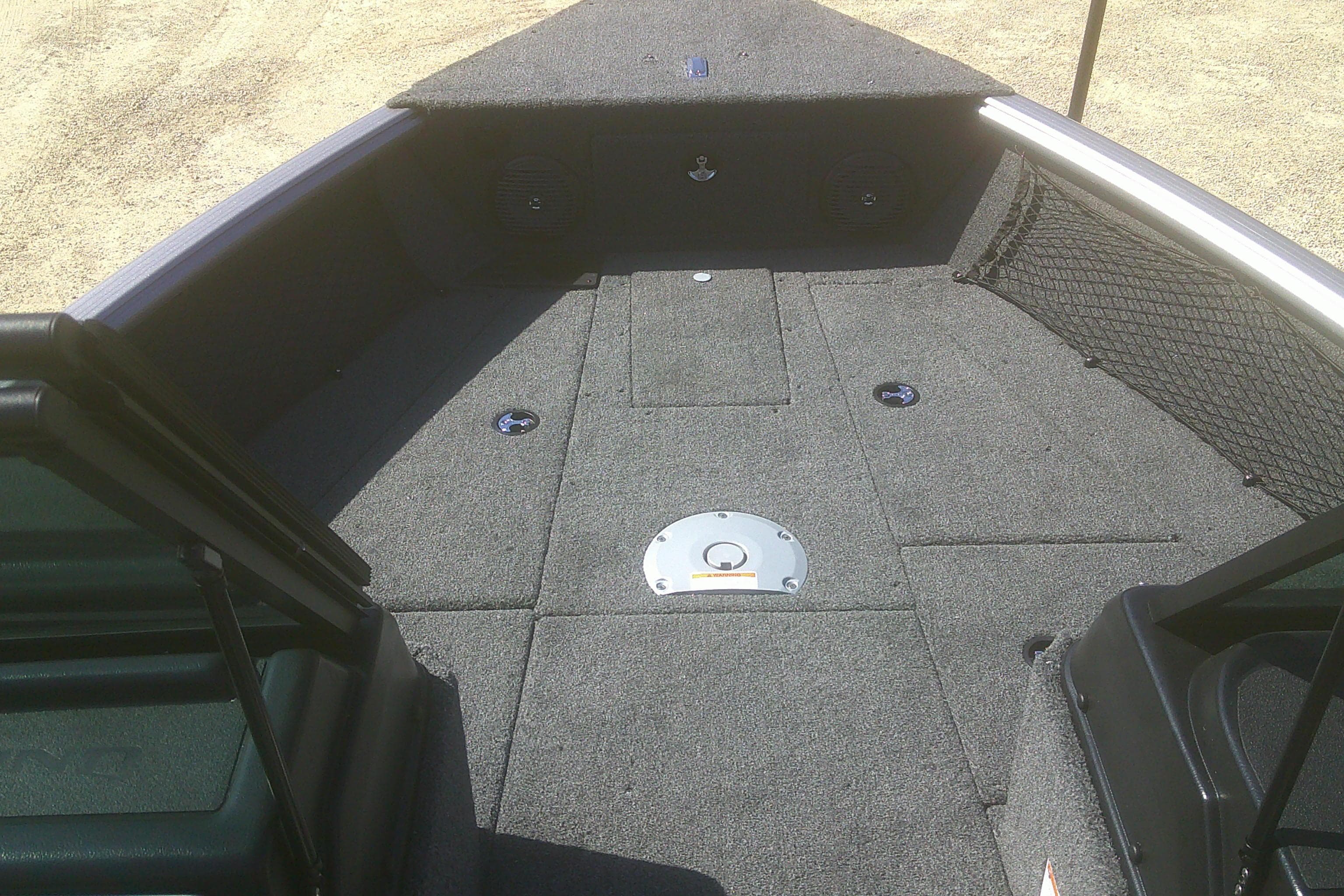 2026 Lund 1775 Impact XS Sport boat interior with carpeted deck and storage compartments.