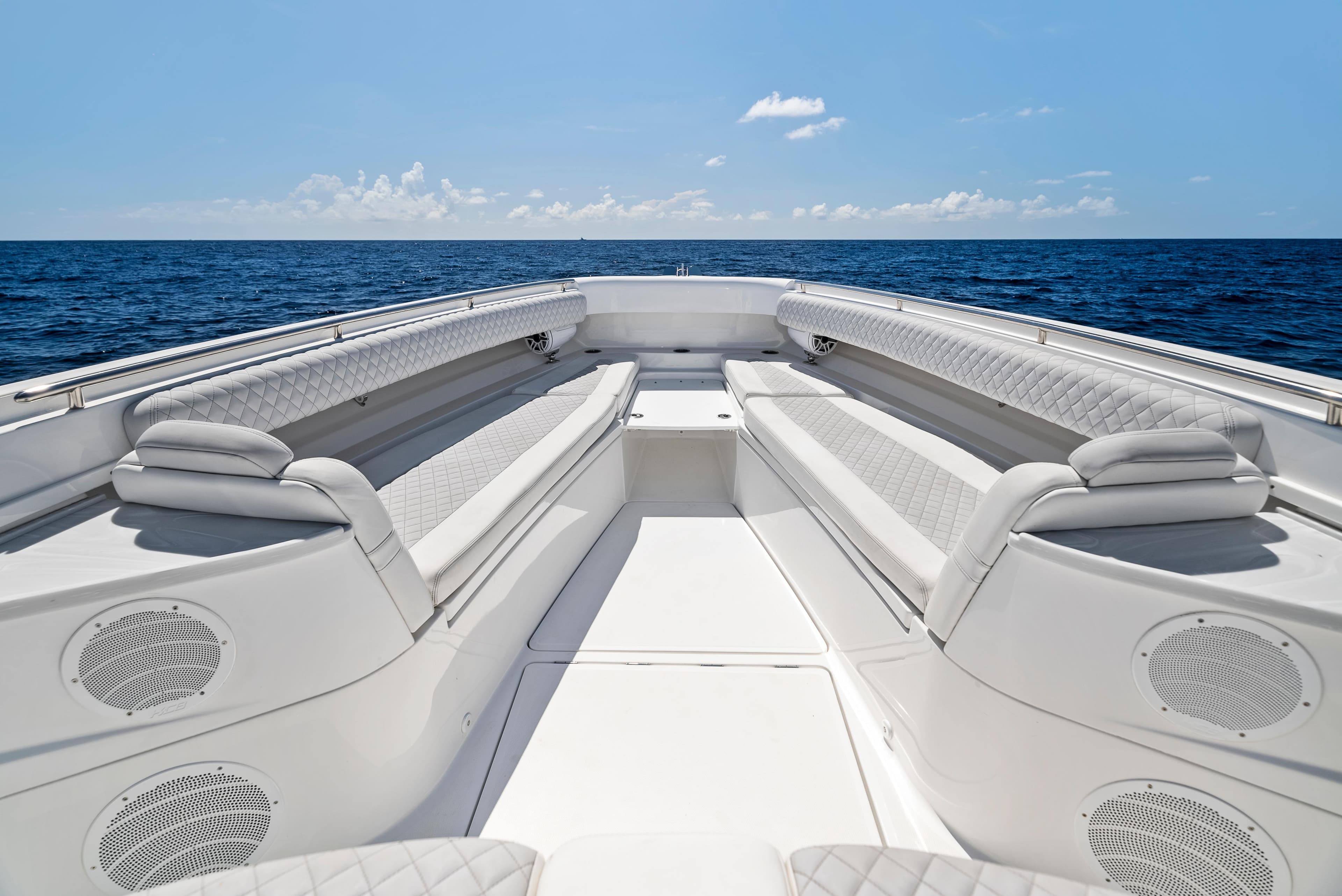 2022 HCB Suenos boat interior with luxurious seating, set against a serene ocean backdrop.