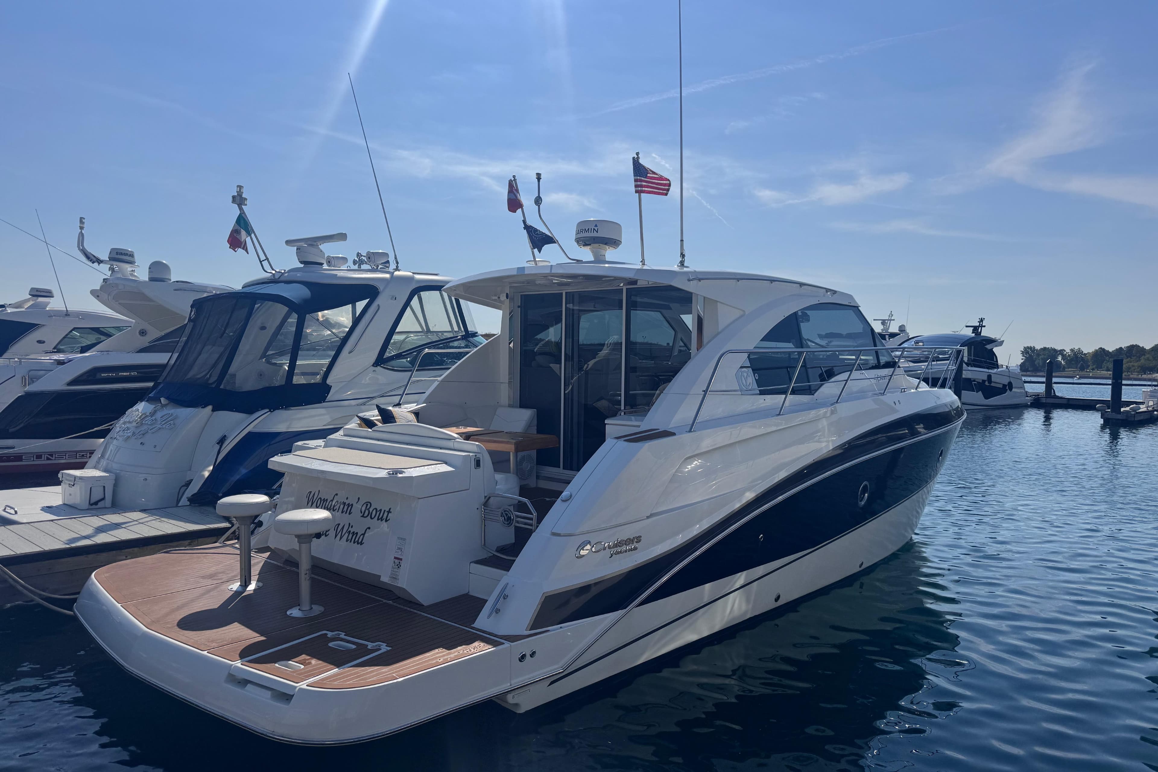 2012 Cruisers Yachts 41 Cantius docked in a marina under clear skies.