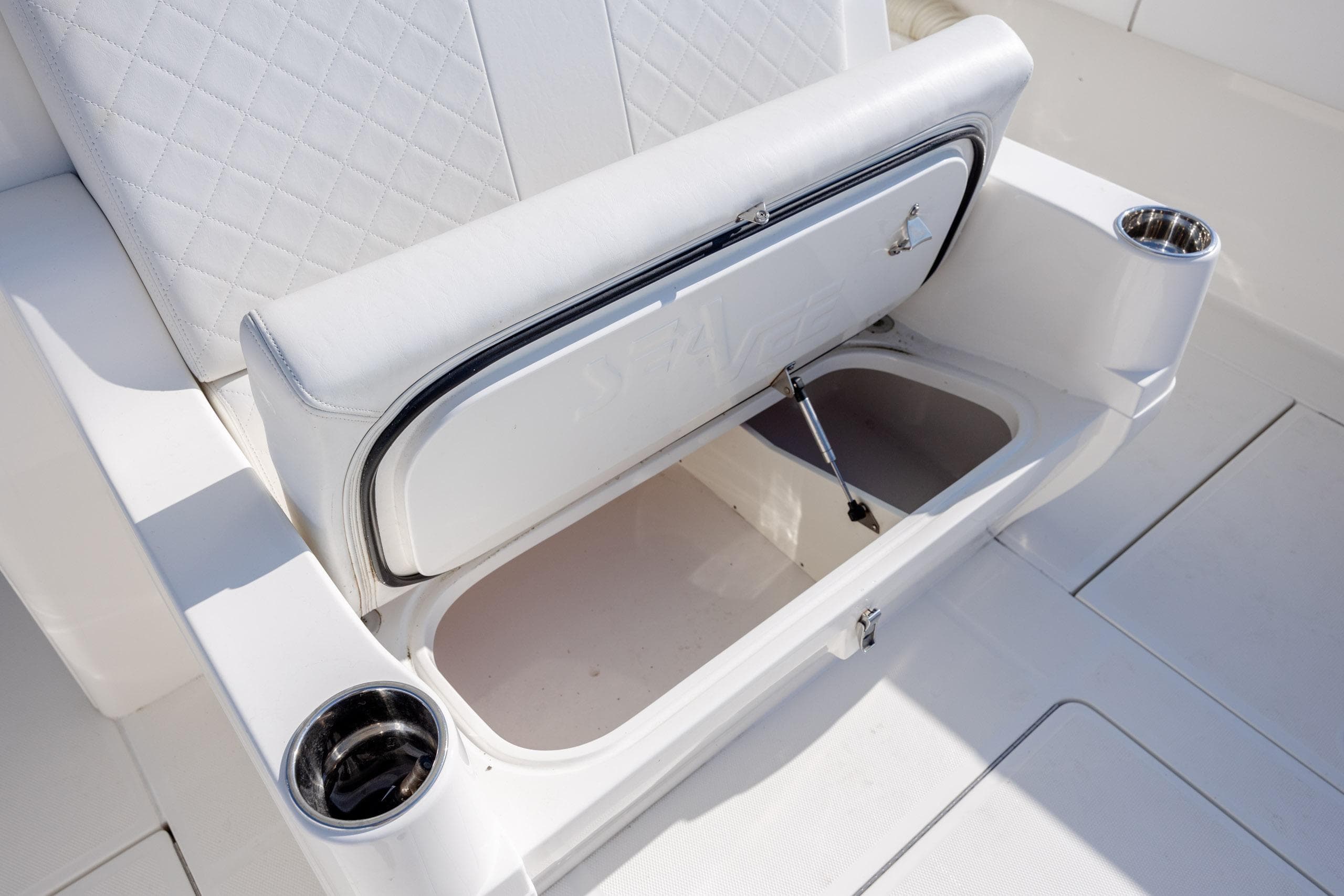 White leather seating with storage compartment on 2019 SeaVee 370Z boat.
