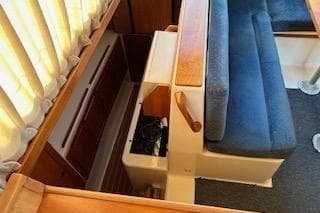 2004 PDQ 34 Power Catamaran interior with blue seating and wooden accents.