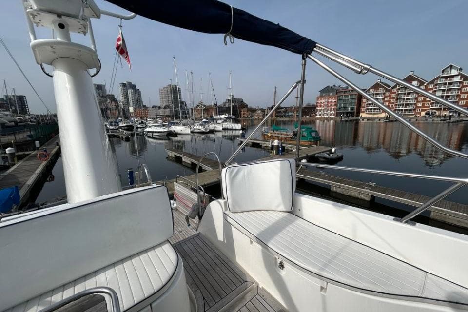 Hardy Commodore 50 yacht docked in marina, cityscape background, 2005 model.