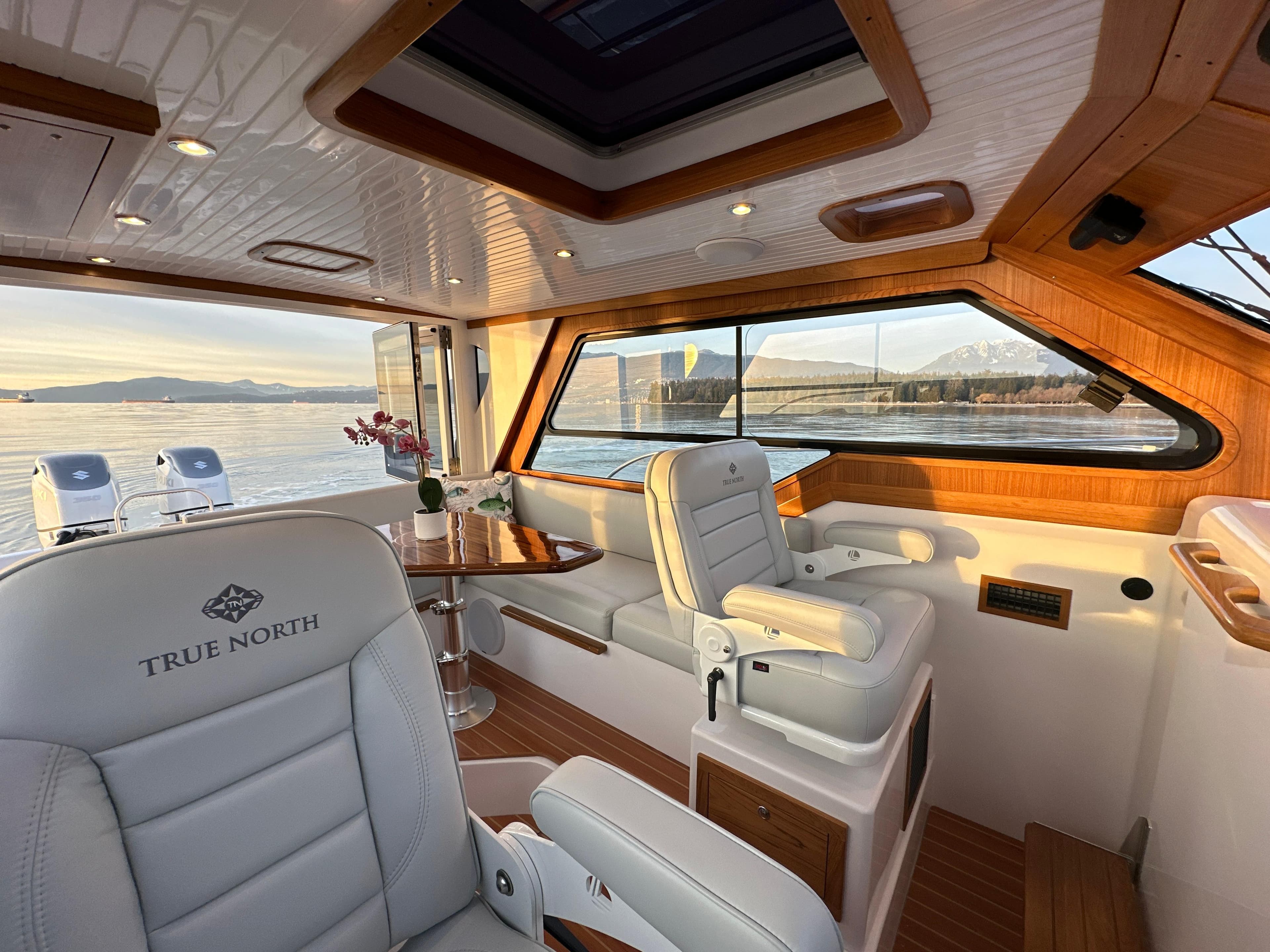2025 True North 34 Outboard Express interior with luxurious seating and scenic ocean view.