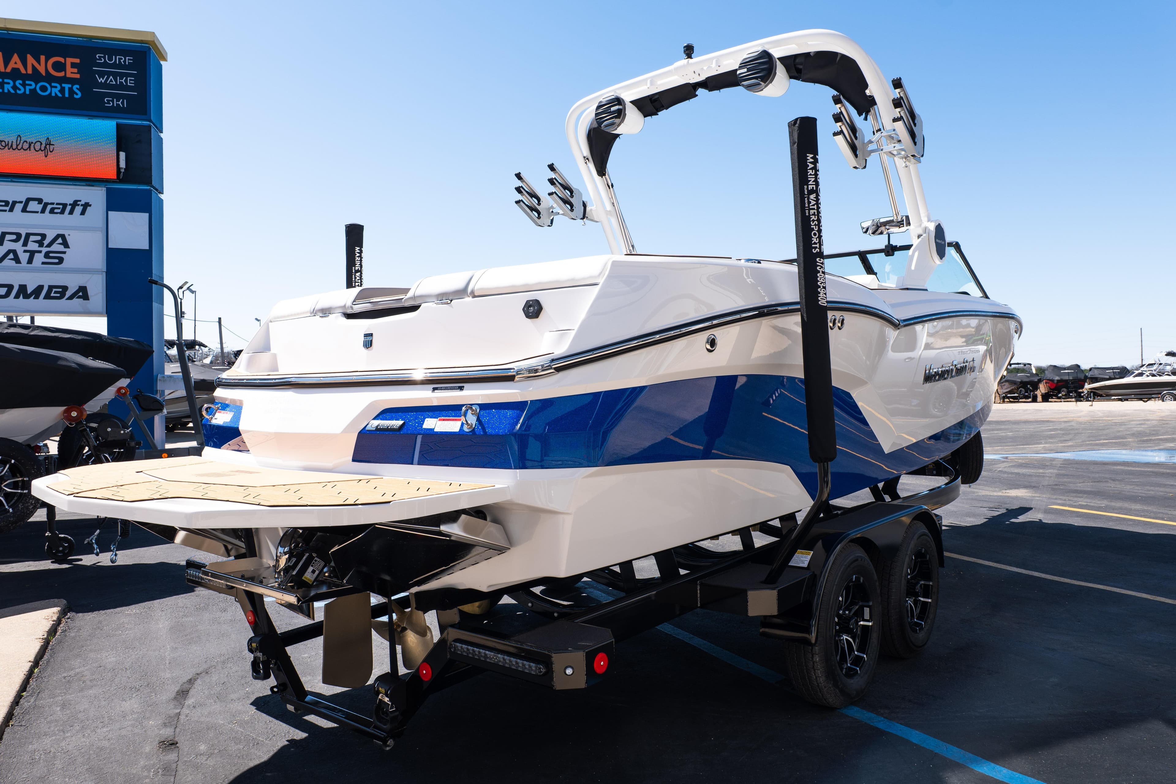 2026 MasterCraft NXT24 boat on trailer, displayed outdoors at a dealership.