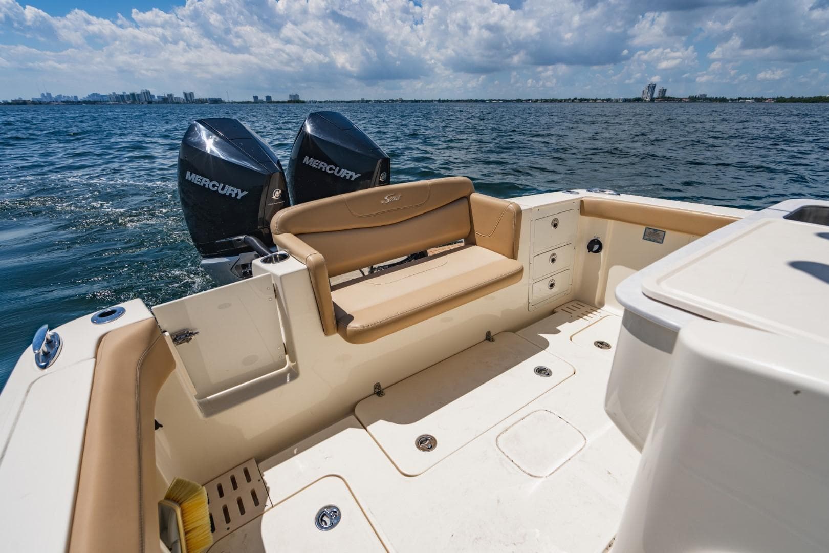 2022 Scout 305 LXF boat with Mercury engines on open water, featuring spacious seating.