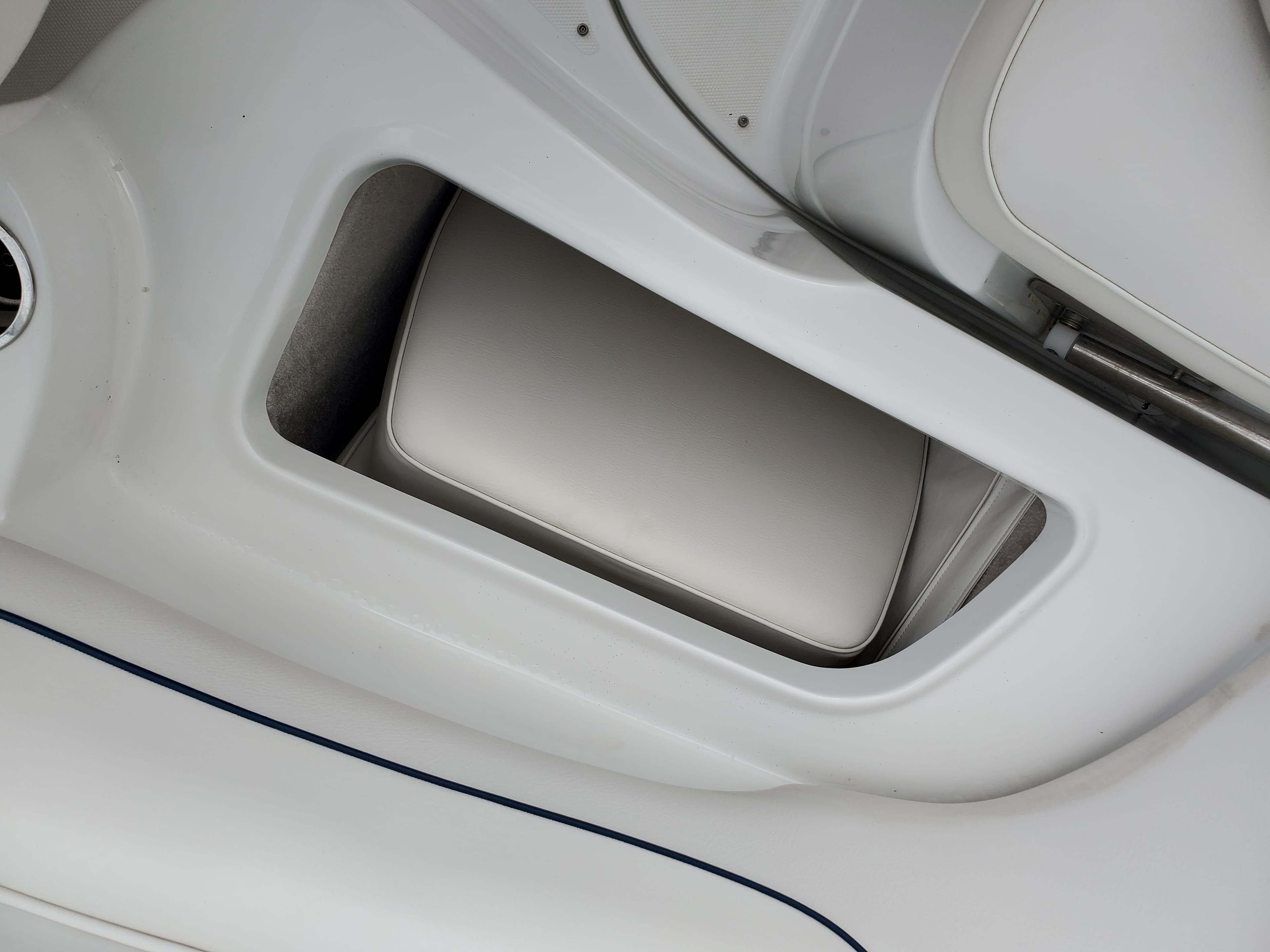 2007 Crownline 220EX boat interior storage compartment with cushioned seating.