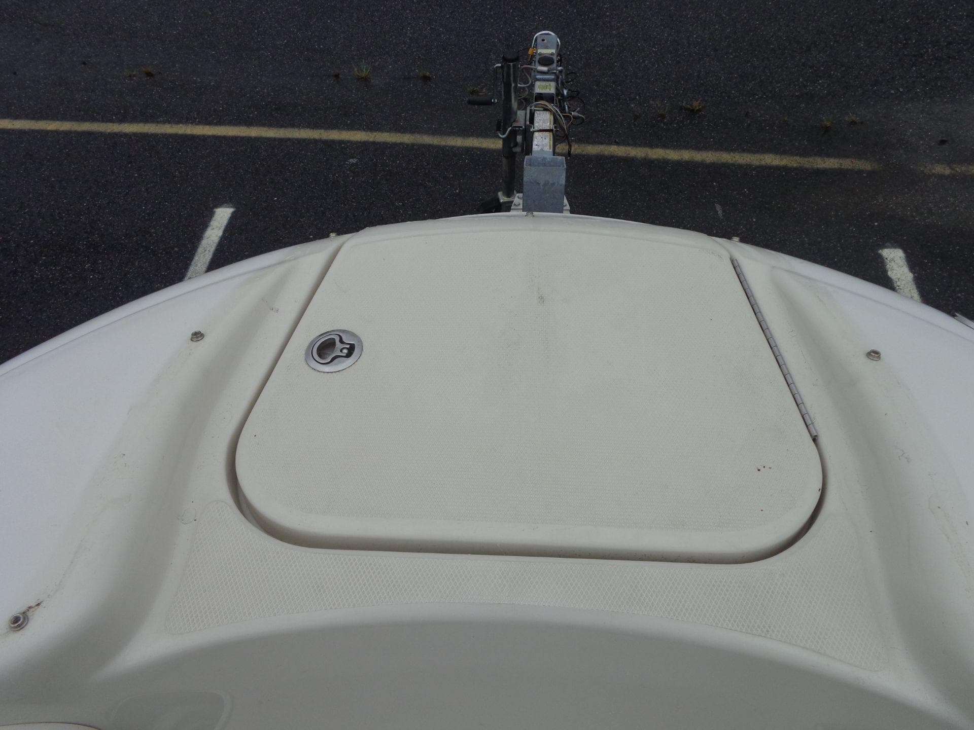 2007 Sea Ray 200 Sundeck boat bow with closed hatch, parked on trailer.