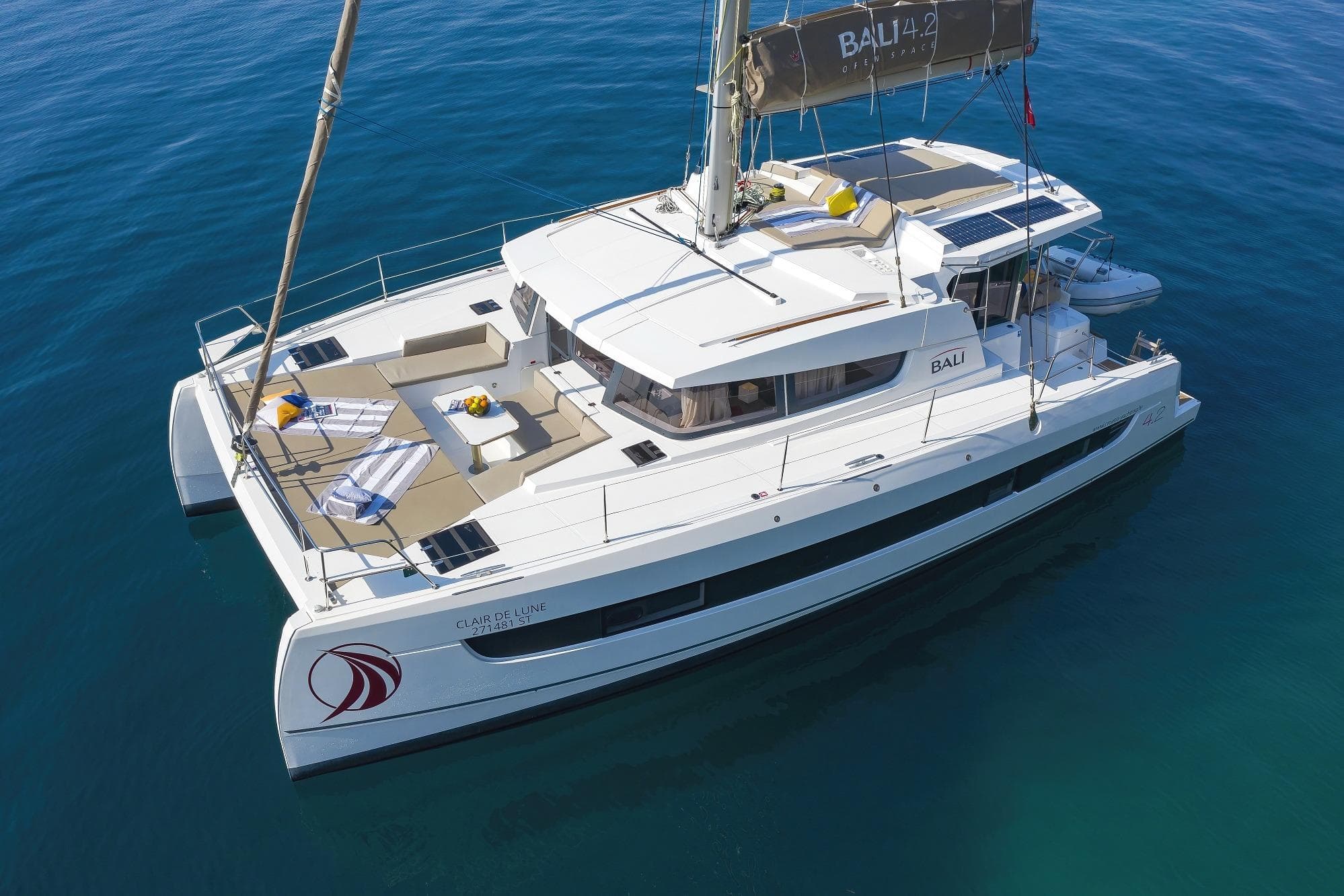 Aerial view of 2021 Bali 4.2 catamaran on calm blue water.