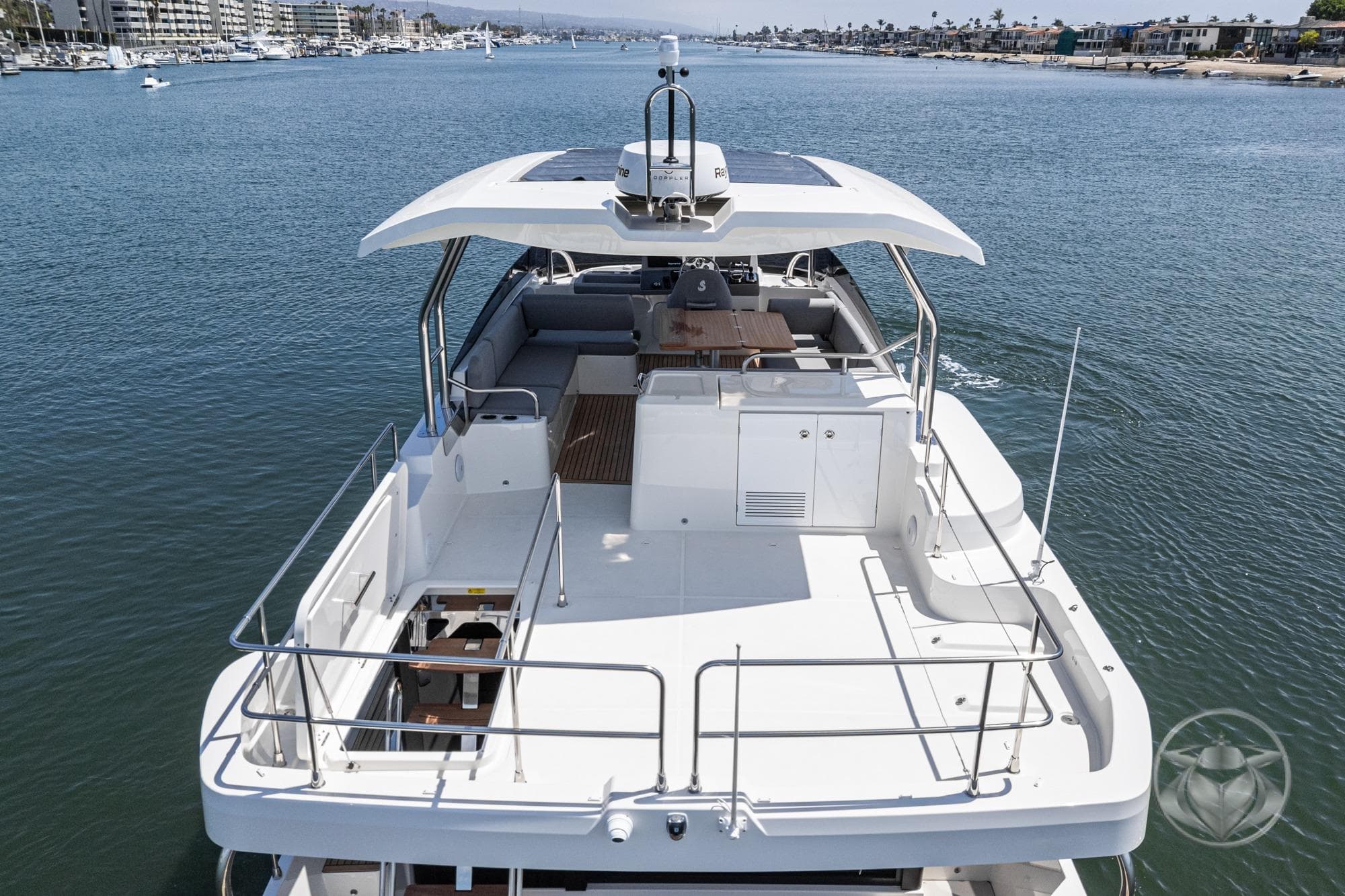 2026 Beneteau Swift Trawler 48 cruising on a calm waterway, showcasing spacious deck.