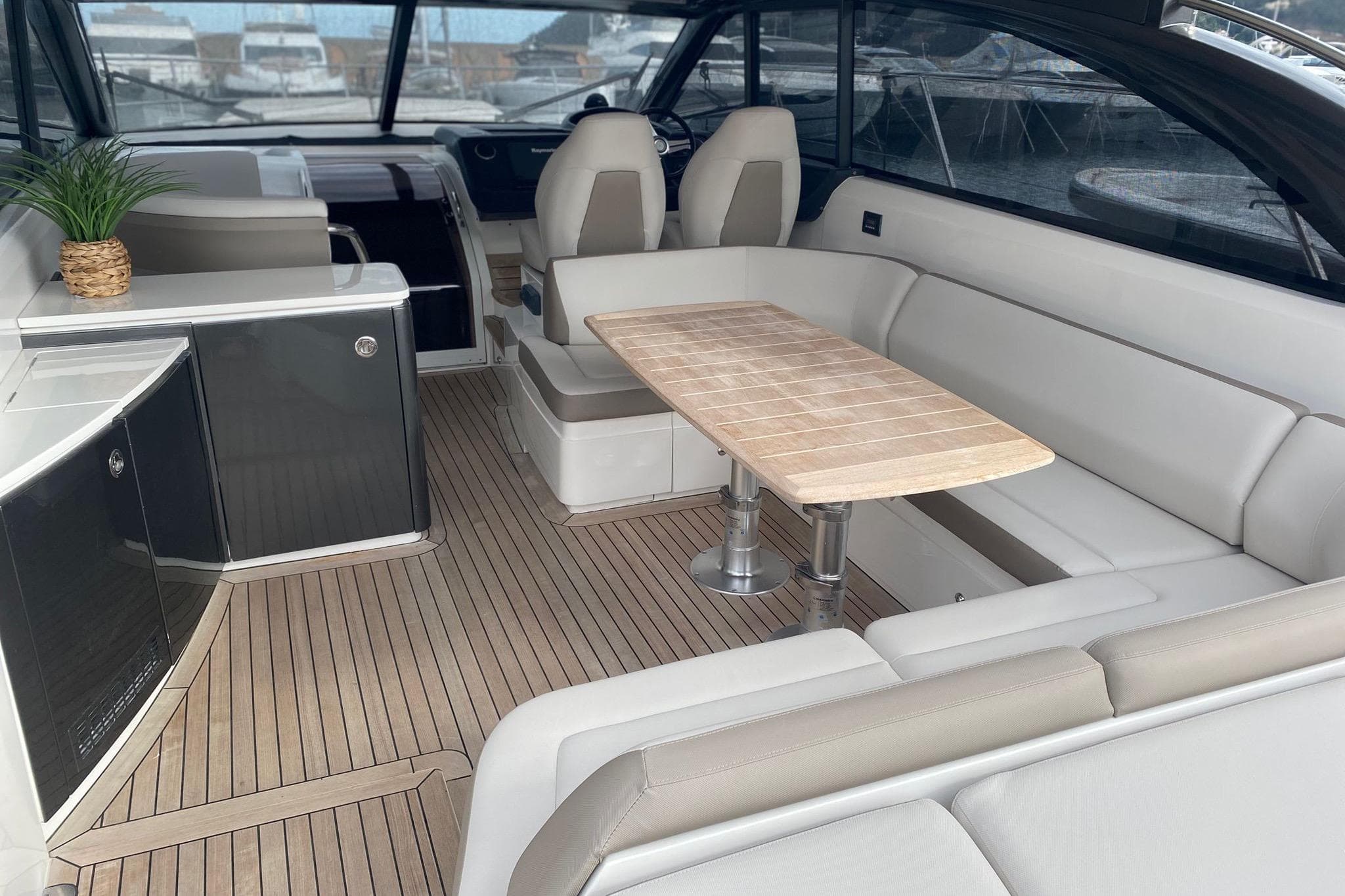 Luxurious interior of 2014 Princess V48 yacht with seating and wooden table.