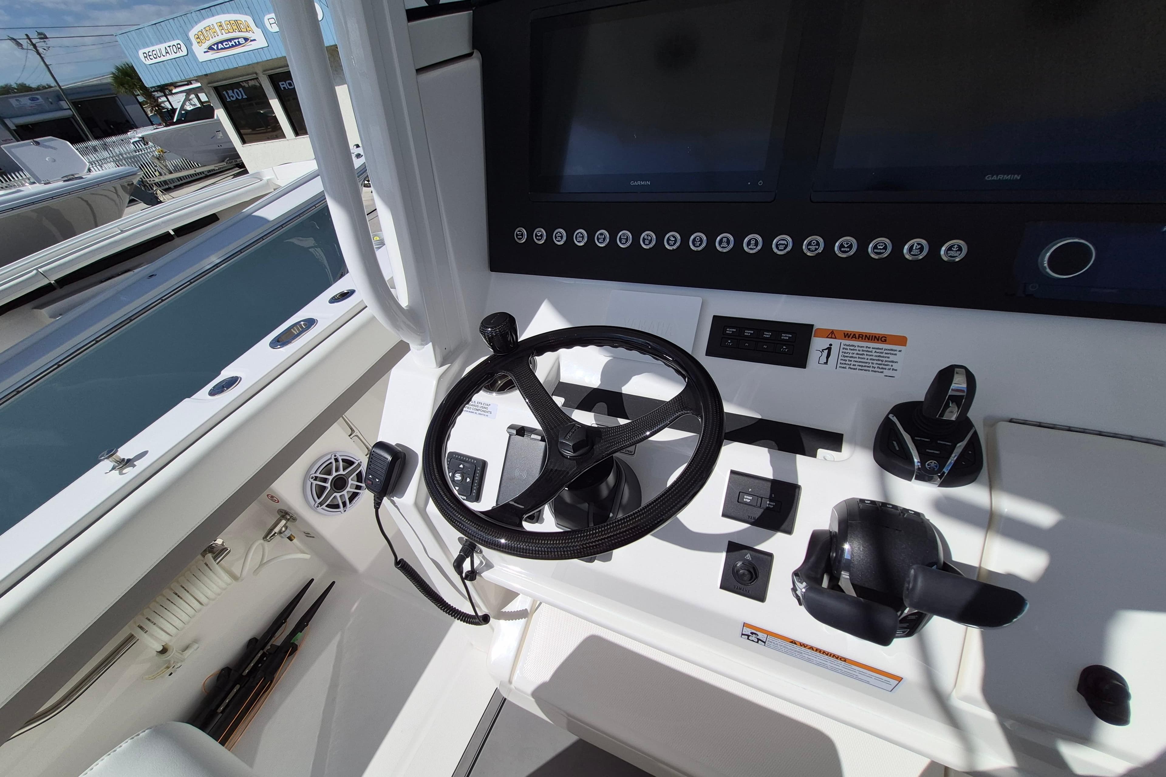 2026 Regulator 31 boat dashboard with steering wheel and controls.