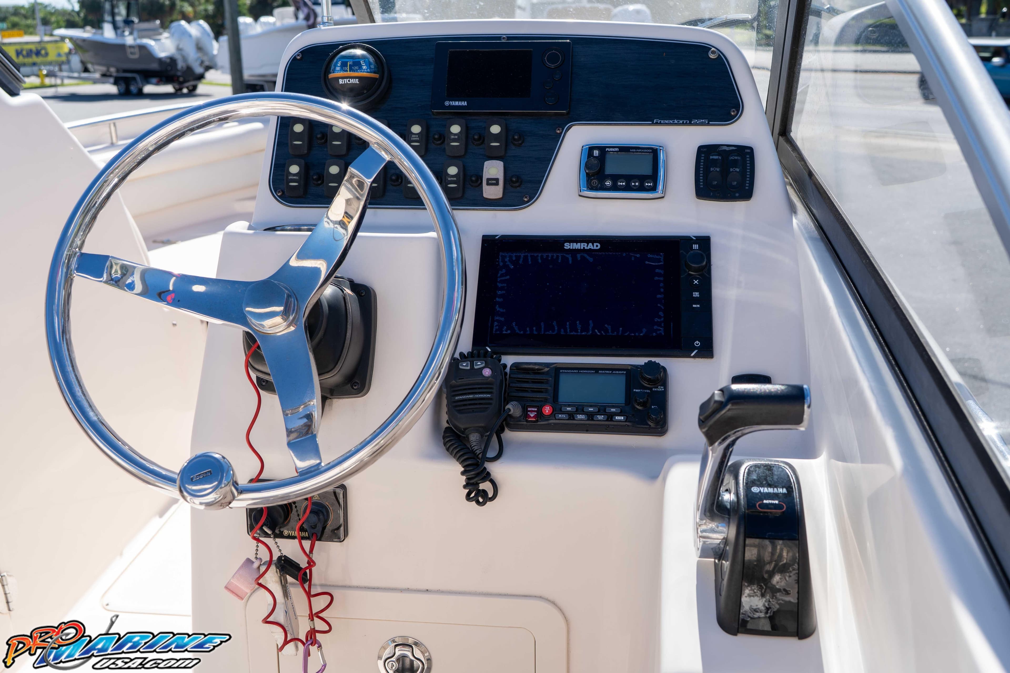 2016 Grady-White Freedom 225 boat dashboard with steering wheel and navigation controls.