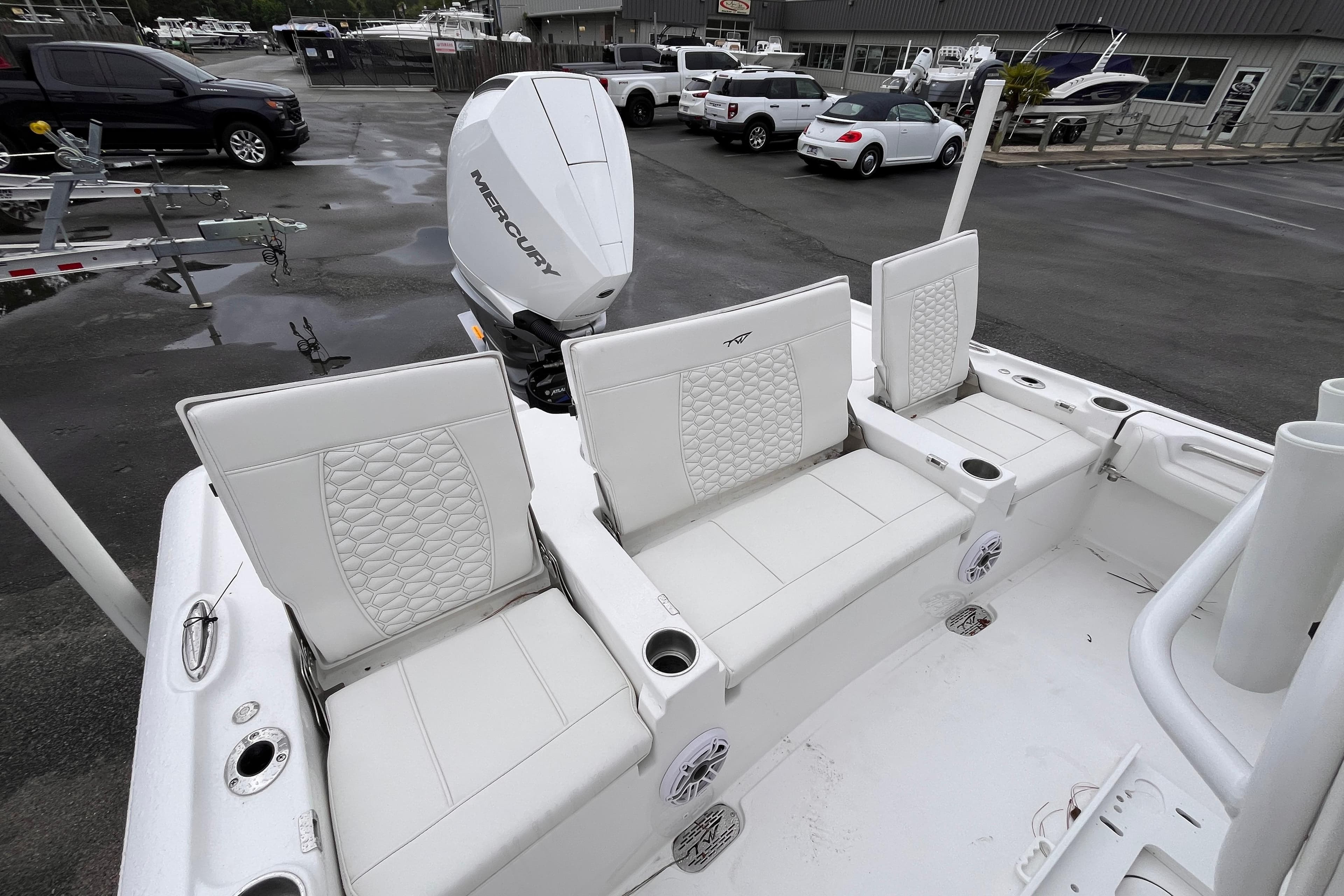 2026 Tidewater 2500 Carolina Bay boat with white seating and Mercury outboard motor.