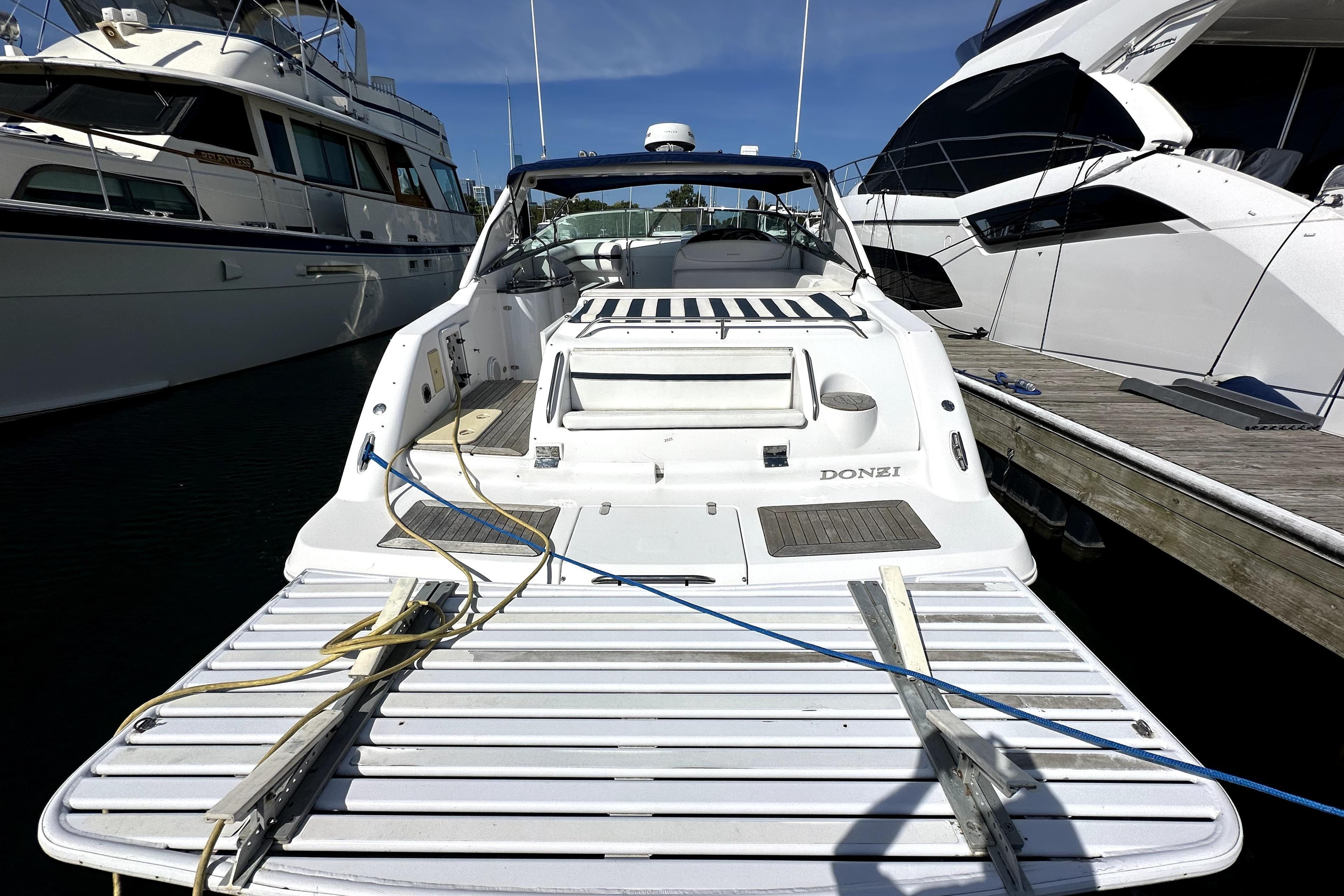 2003 Donzi 39 ZSC boat docked at marina, featuring sleek white design.