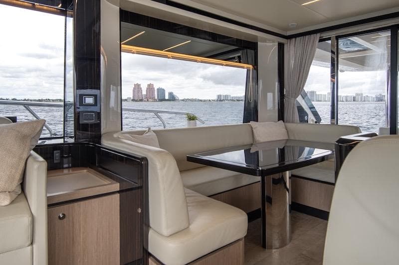 Luxurious interior of 2023 Absolute 62 Fly yacht with waterfront view.