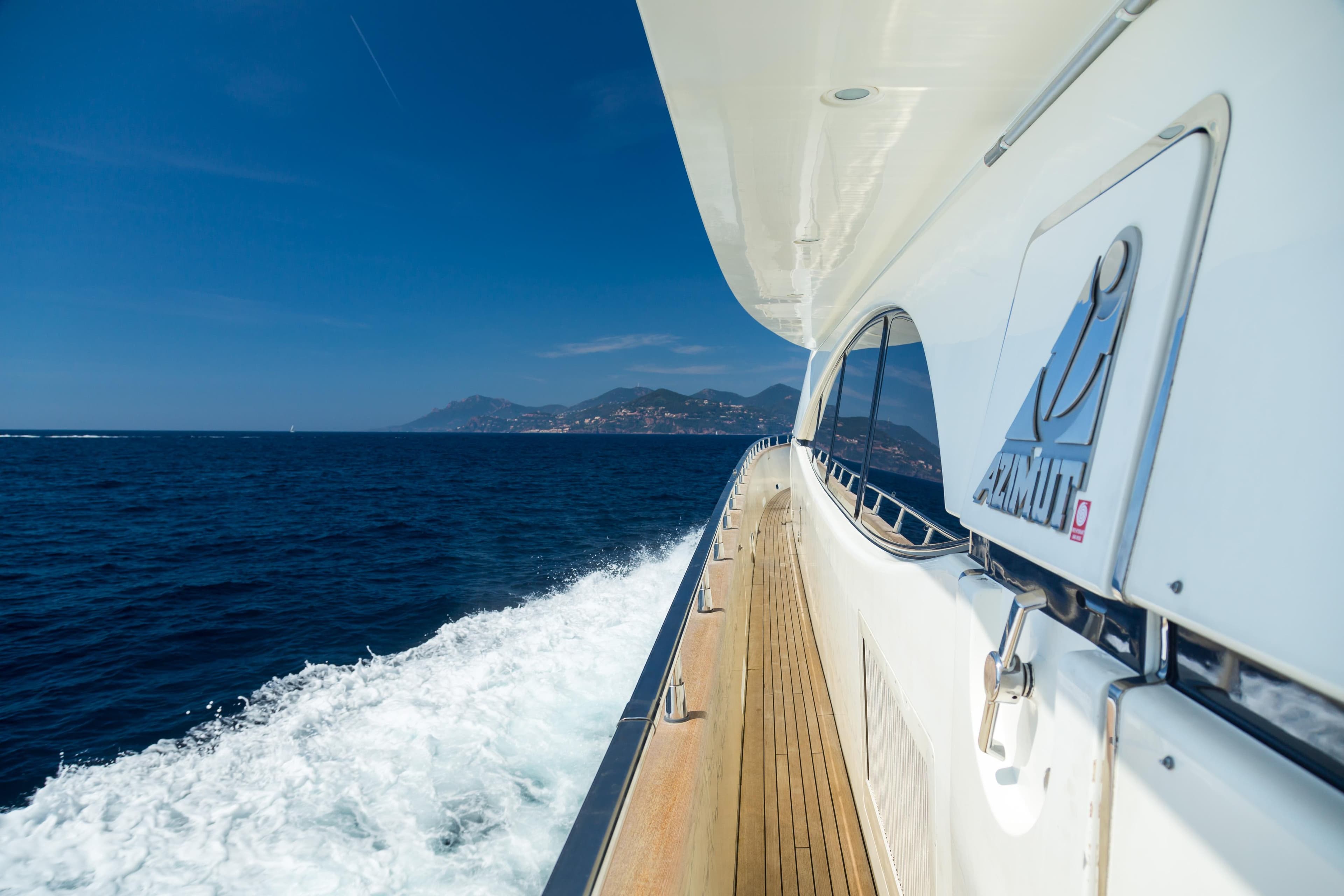 Azimut Jumbo 100 yacht cruising on open sea, 1999 model, with scenic coastal view.
