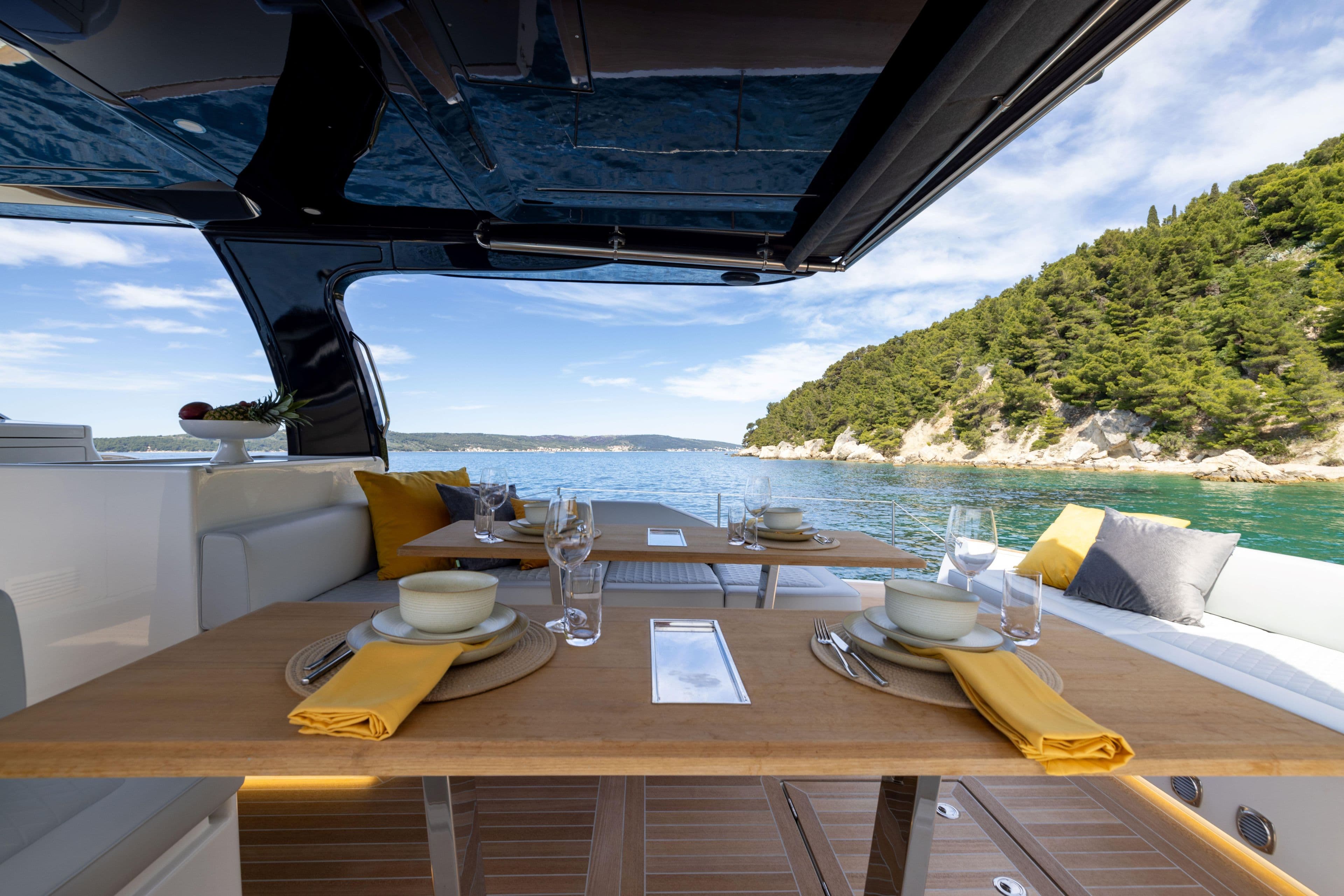 Luxurious dining setup on 2025 Solaris Power 60 Open yacht, with scenic ocean view.