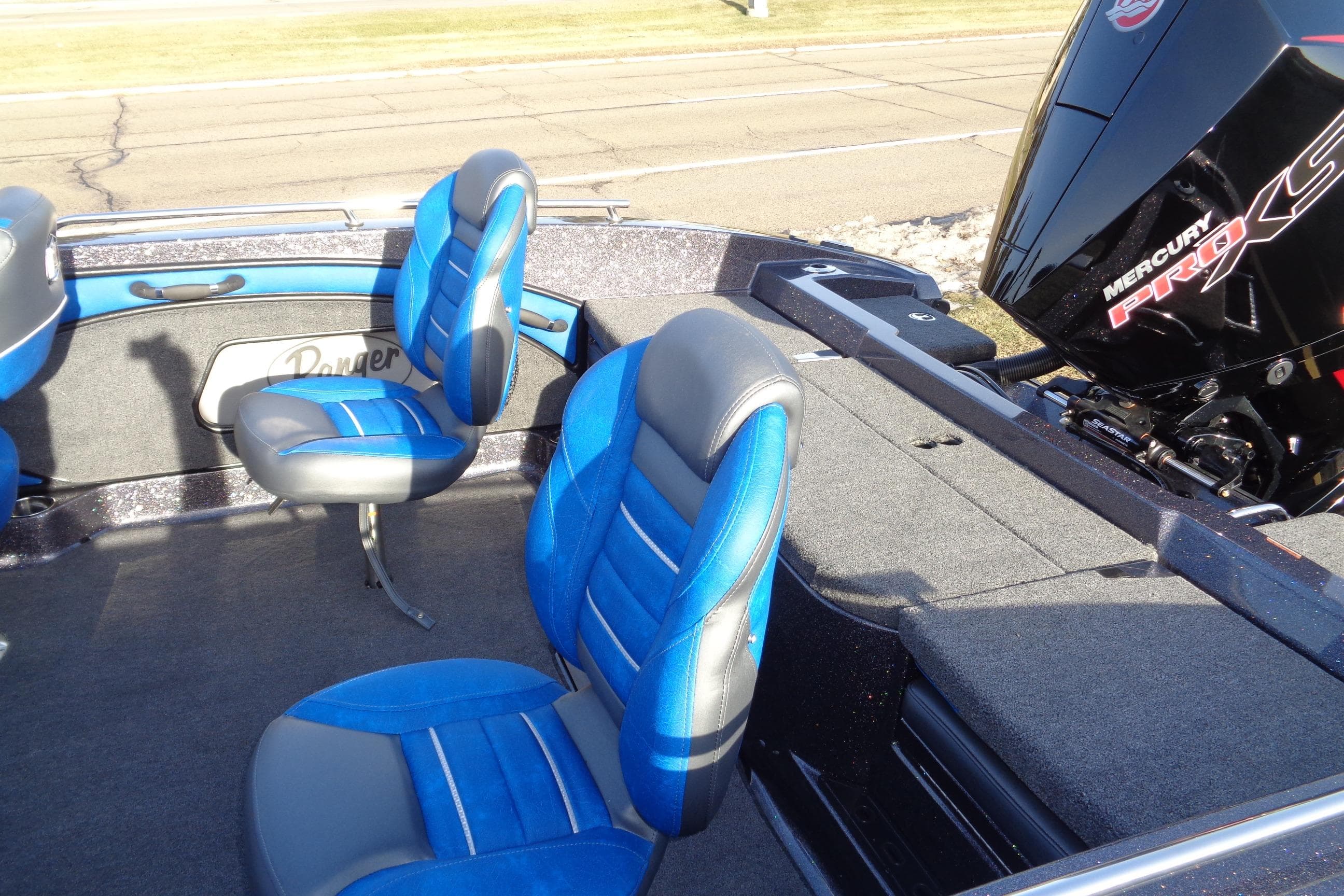 2026 Ranger 1880MS Angler boat interior with blue seats and Mercury Pro XS engine.