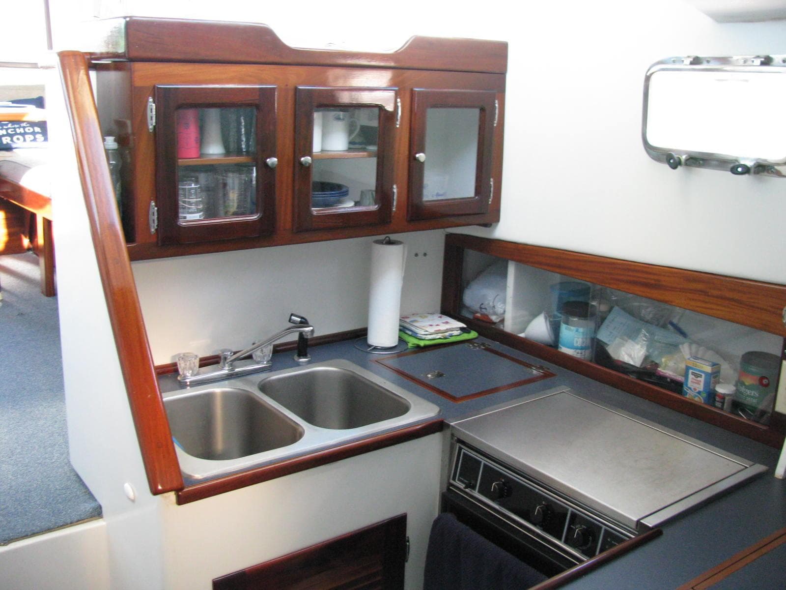 Compact kitchen in 1998 Duffy 35 Downeast Cruiser with dual sinks and wooden cabinets.