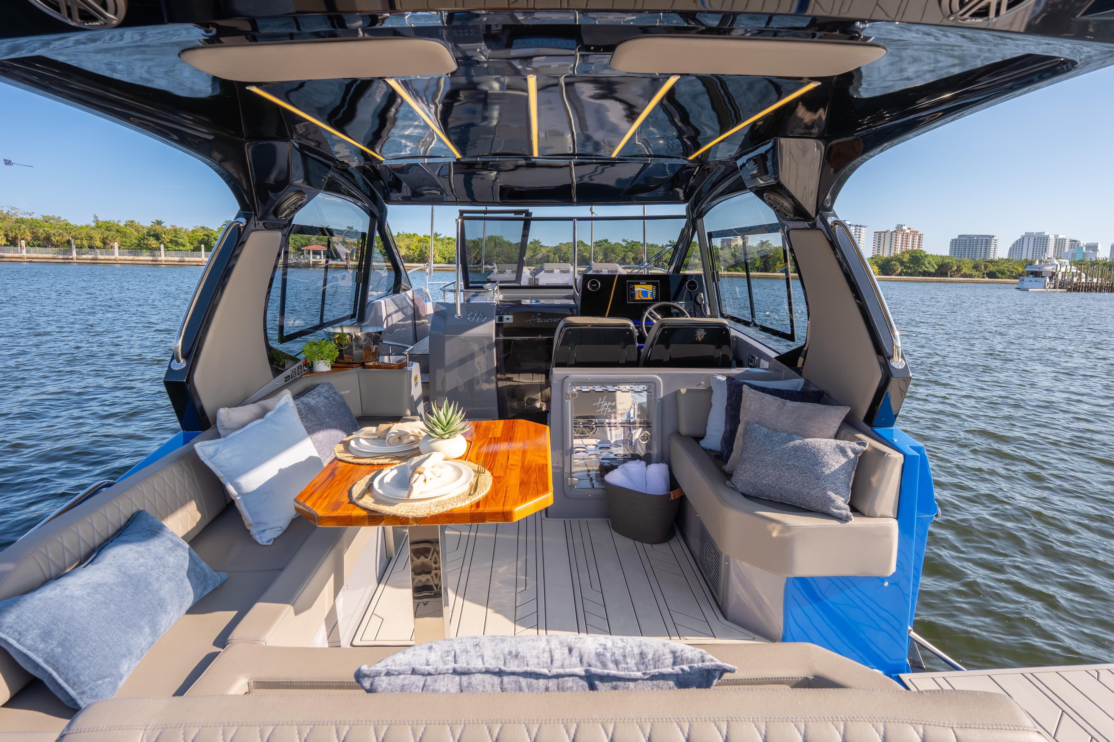 Luxurious 2026 Hanover 347 yacht interior with elegant seating and dining area on the water.