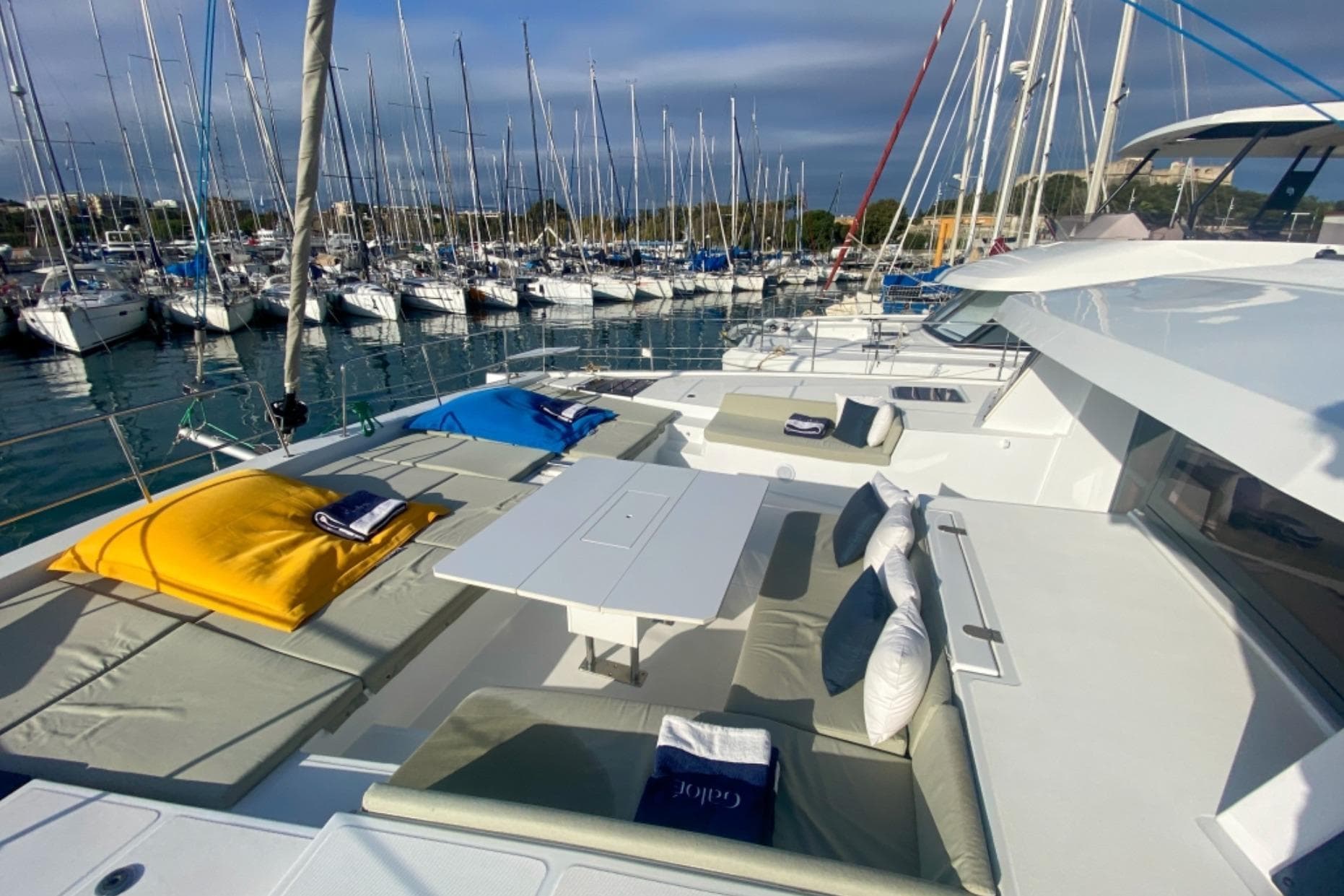 Luxurious 2023 Bali 5.4 yacht with spacious deck and comfortable seating in marina.