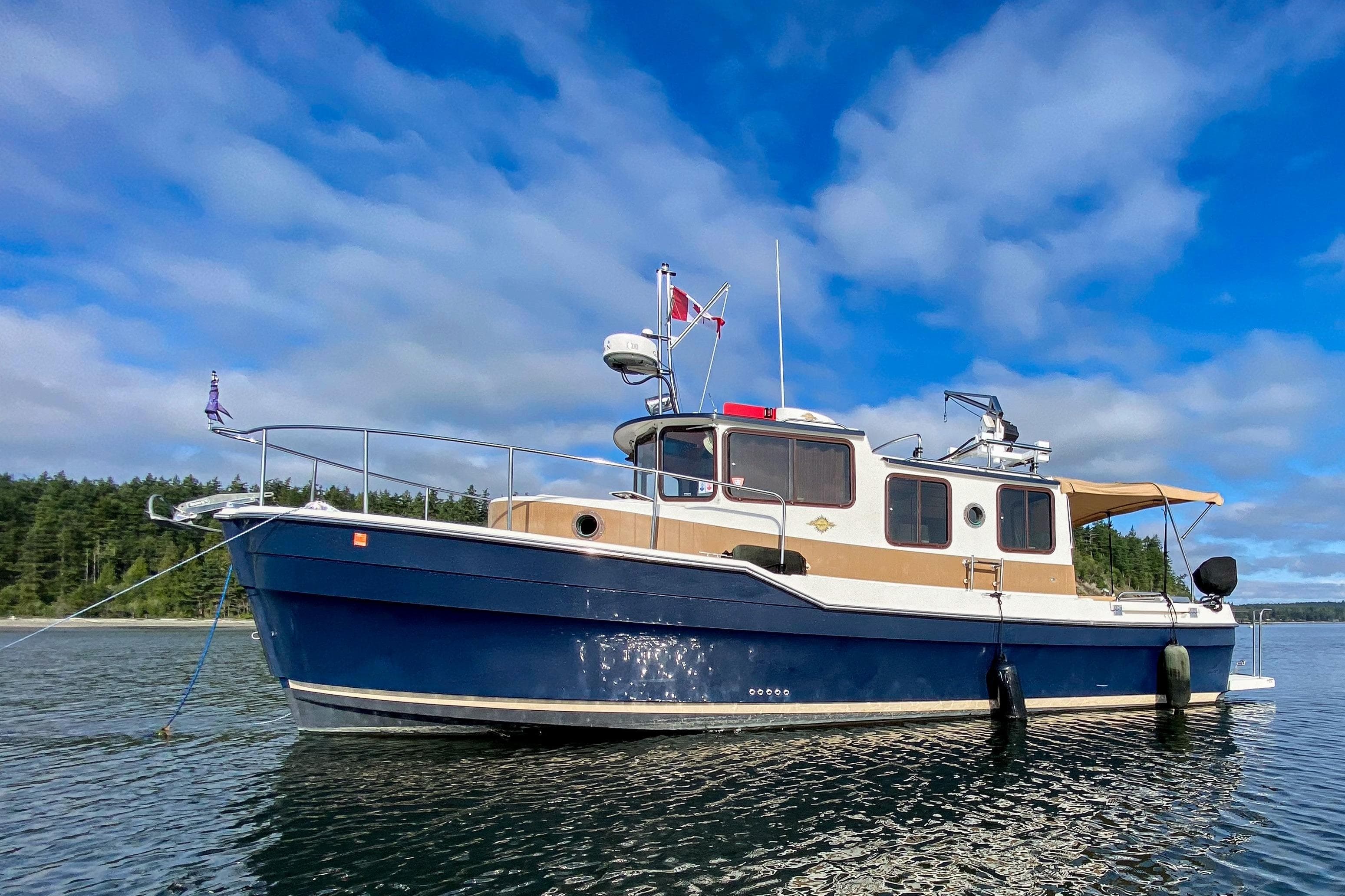 2010 Ranger Tugs R-29 boat on calm water under blue sky.