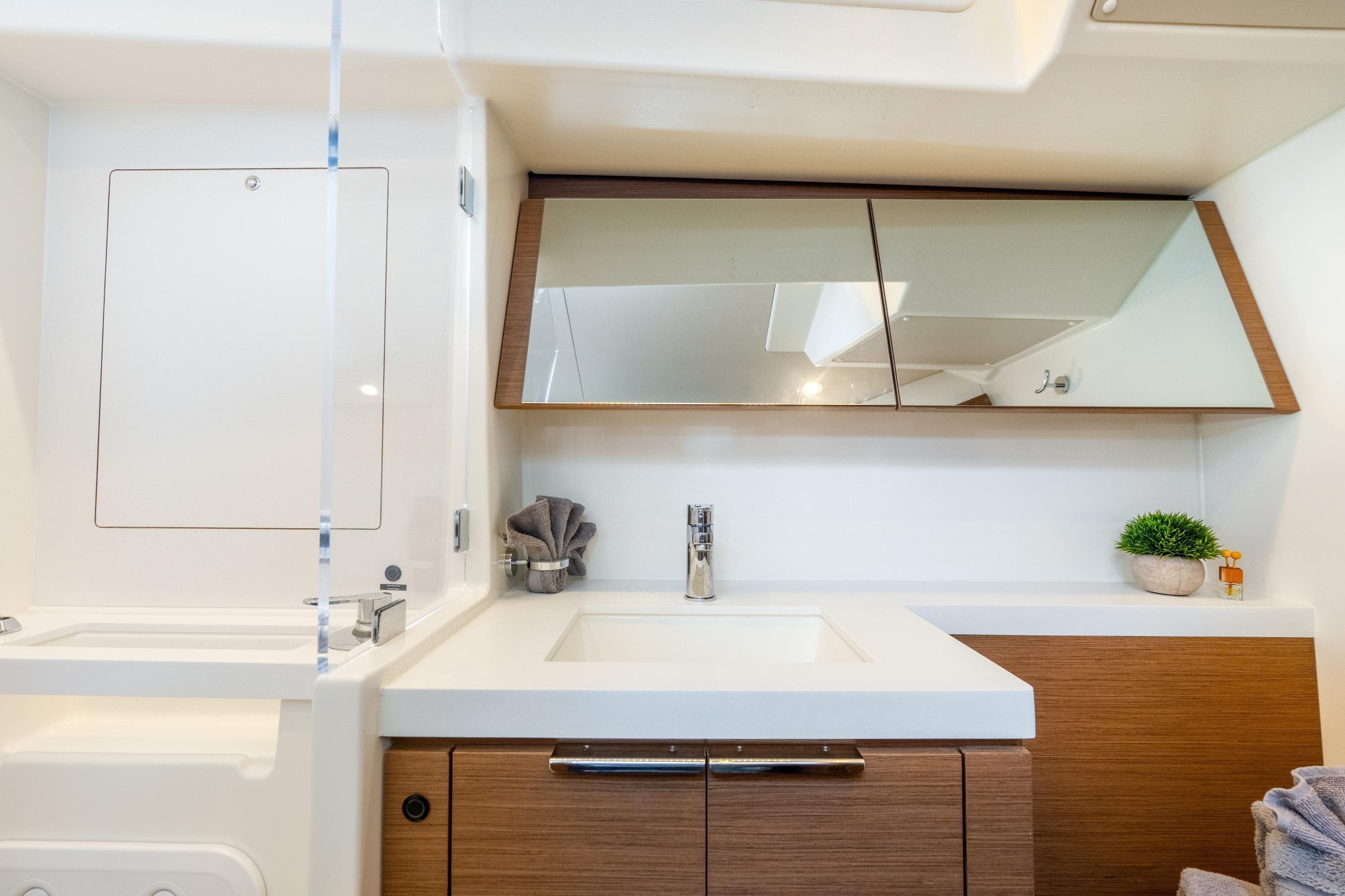 Luxurious bathroom interior of 2021 Beneteau Oceanis Yacht 54 with modern fixtures.