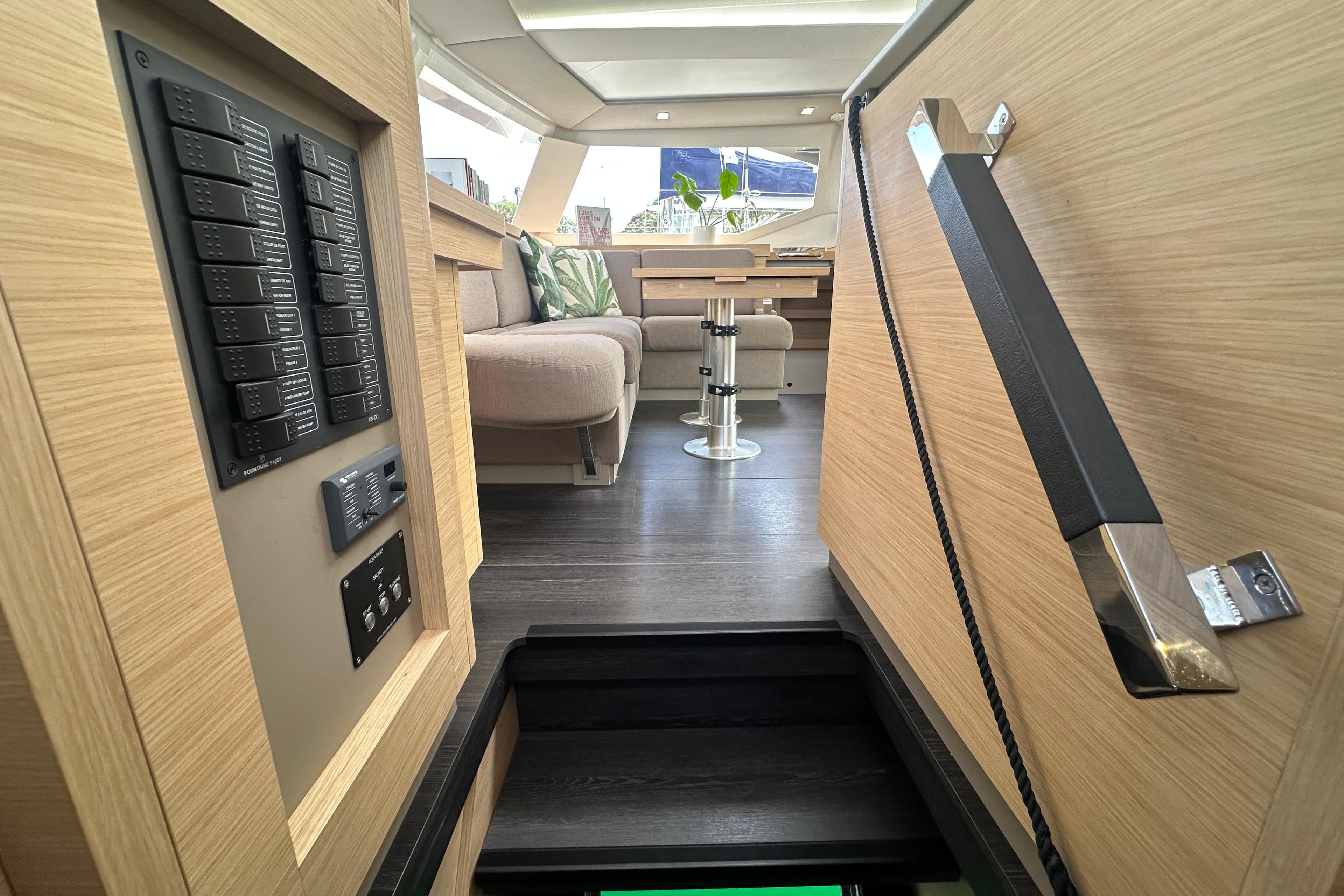 Interior of 2024 Fountaine Pajot Astrea 42 catamaran, featuring modern design and control panel.