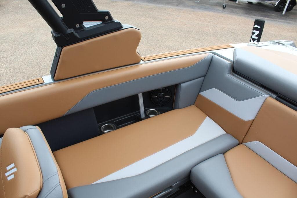 2024 ATX Surf Boats 22 Type-S interior with tan and gray seating, featuring cup holders and speakers.