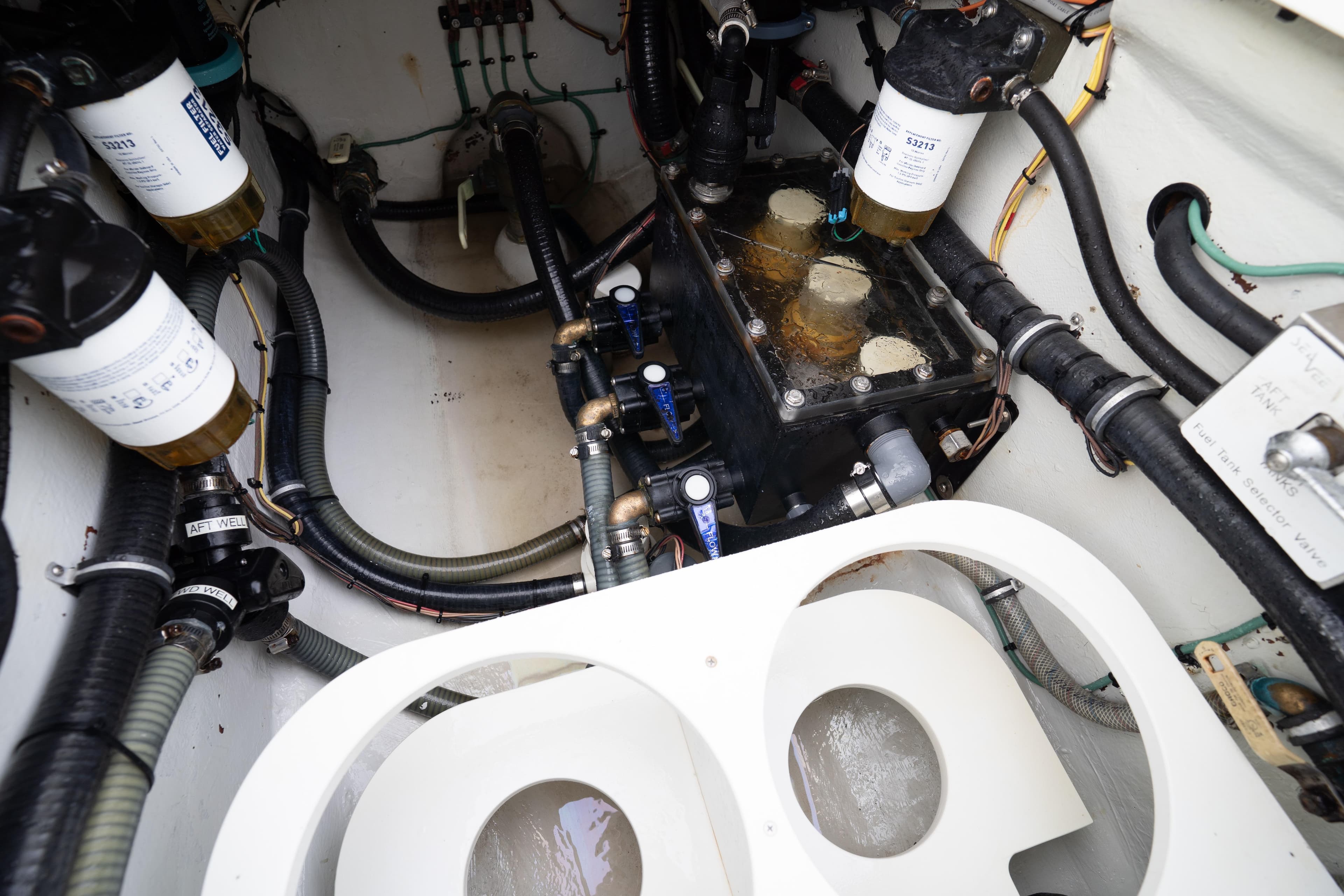 Engine compartment of a 2015 SeaVee 39Z boat, showcasing filters and hoses.