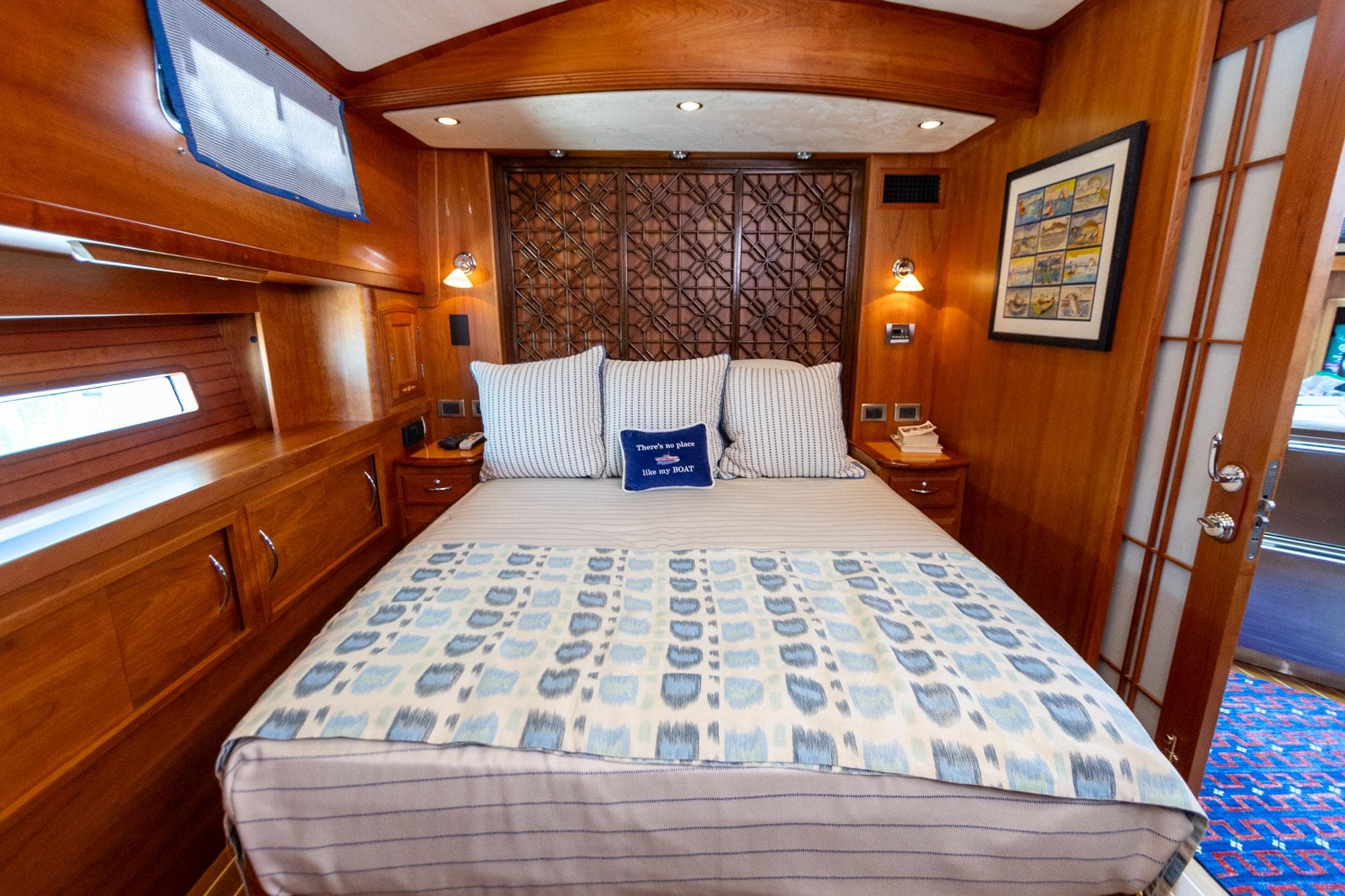 Luxurious cabin interior of 2009 Sabre 52 Express yacht with elegant bedding and wood finish.