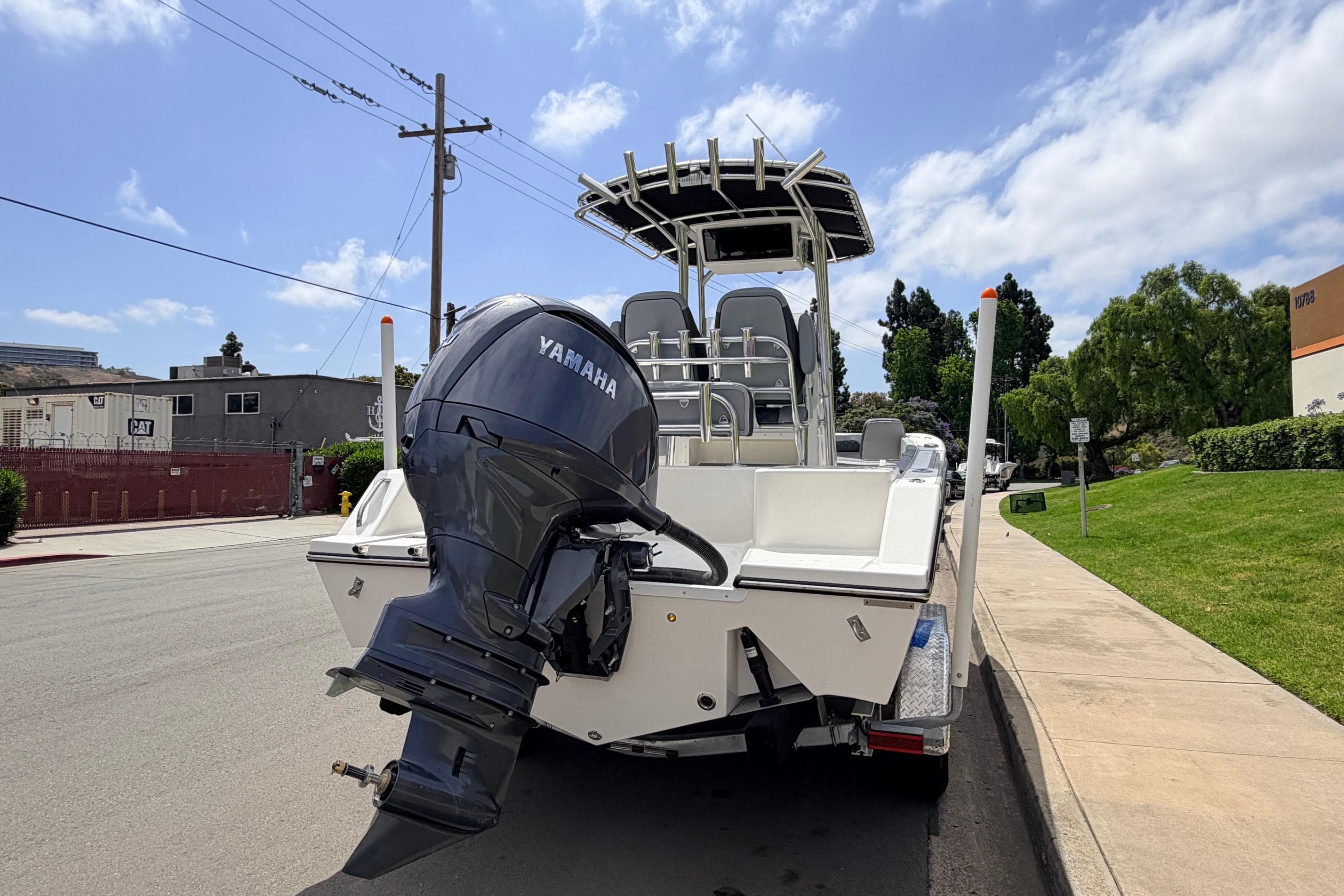 2026 Defiance Catalina 210 boat with Yamaha outboard motor on a sunny street.
