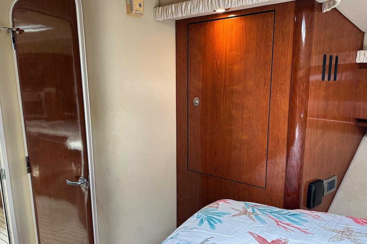 Interior of 2004 Sea Ray 420 Sundancer with wooden cabinetry and door.
