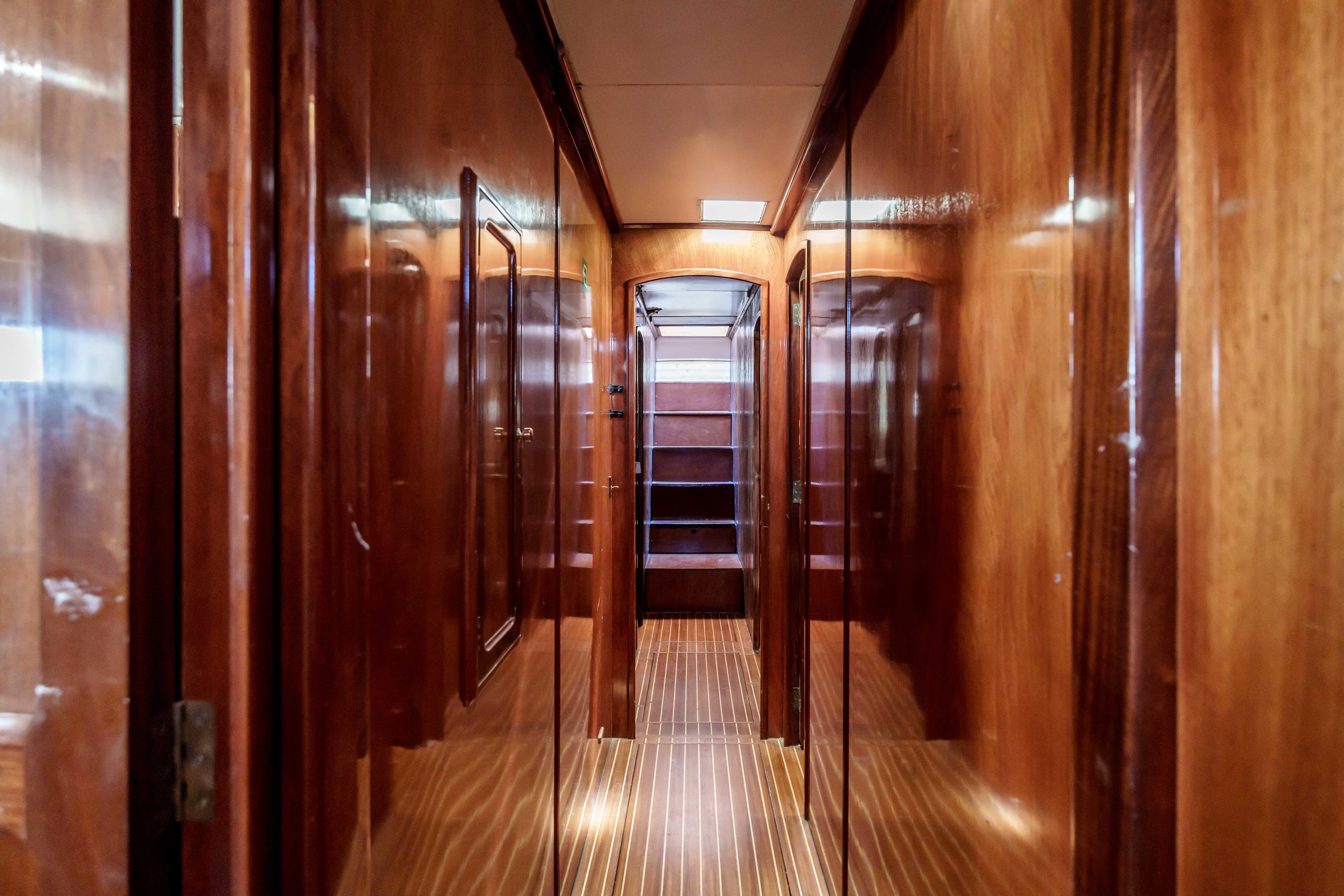 Luxurious wooden interior hallway of 1983 Cavalier 92 yacht.
