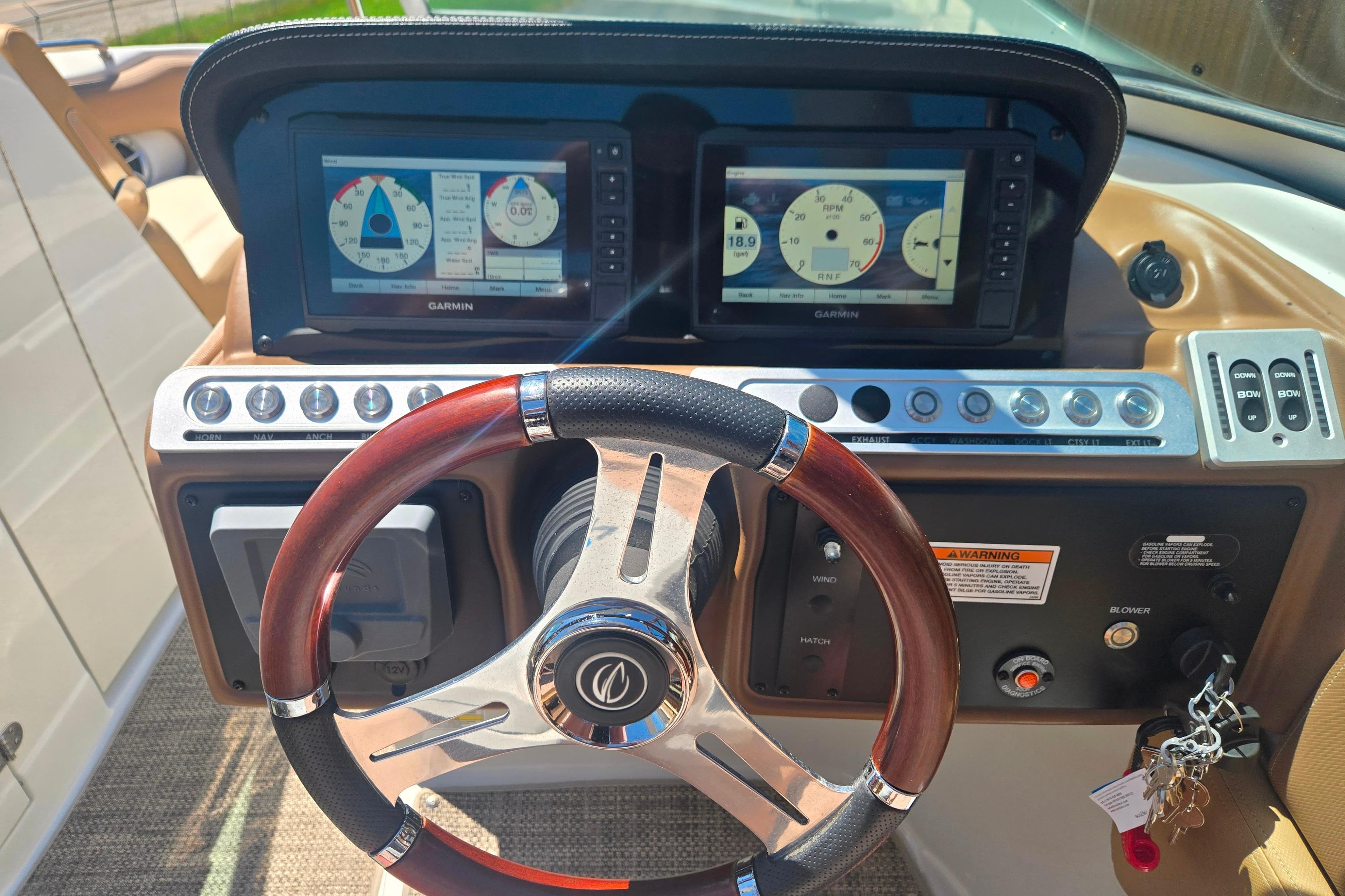 2021 Crownline Eclipse E235 dashboard with Garmin displays and wood-accented steering wheel.